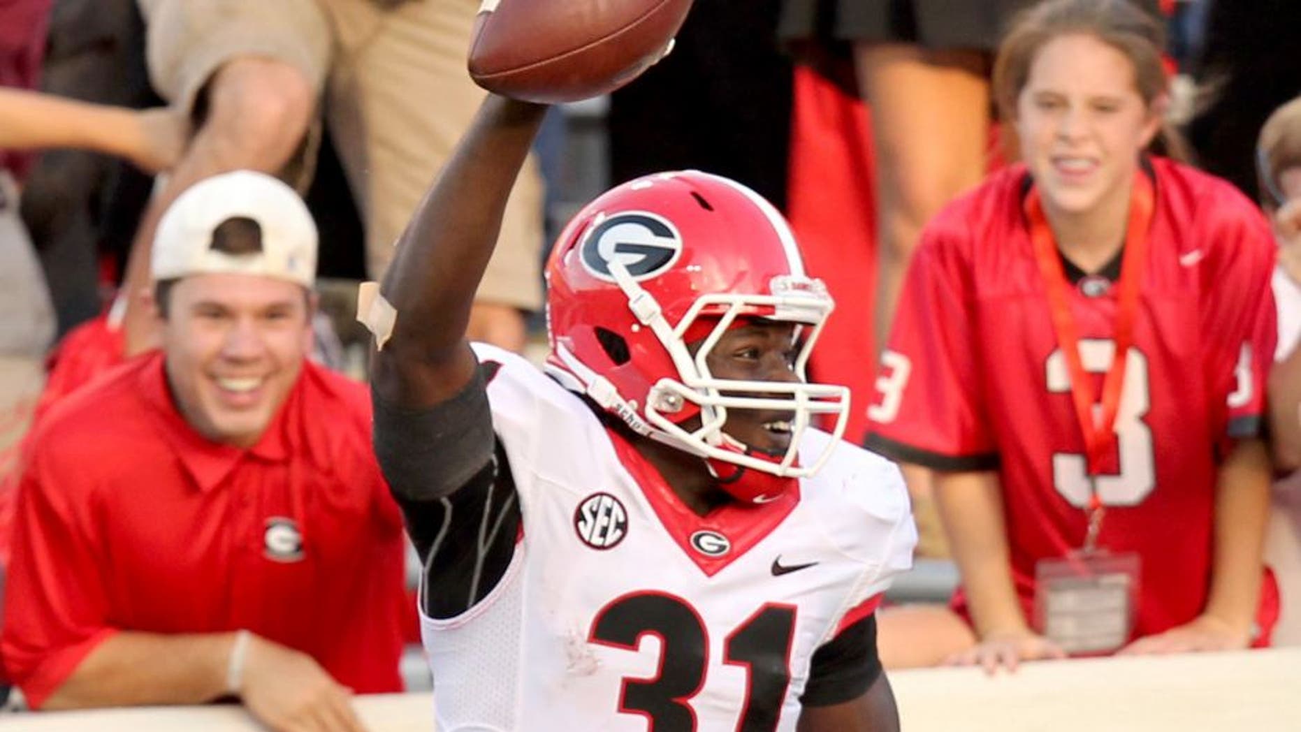 Oct 18, 2014; Little Rock, AR, USA; Georgia Bulldogs flanker Chris Conley (31) celebrates with tight end Jay Rome (87) after catching a pass for a touchdown defended by Arkansas Razorbacks cornerback Jared Collins (29) at War Memorial Stadium. Georgia defeated Arkansas 45-32. Mandatory Credit: Nelson Chenault-USA TODAY Sports