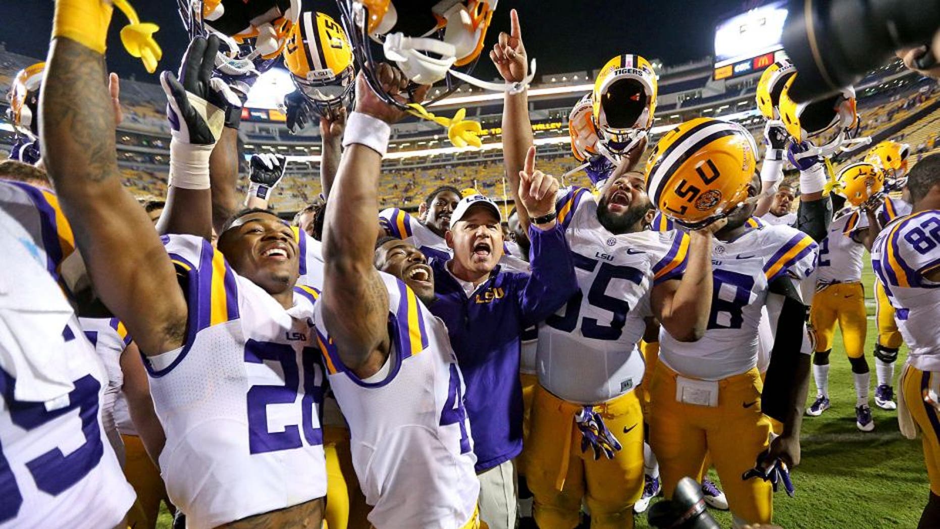 Oct 18, 2014; Baton Rouge, LA, USA; LSU Tigers head coach Les Miles and the Tigers celebrate their 41-3 victory against the Kentucky Wildcats at Tiger Stadium. Mandatory Credit: Crystal LoGiudice-USA TODAY Sports