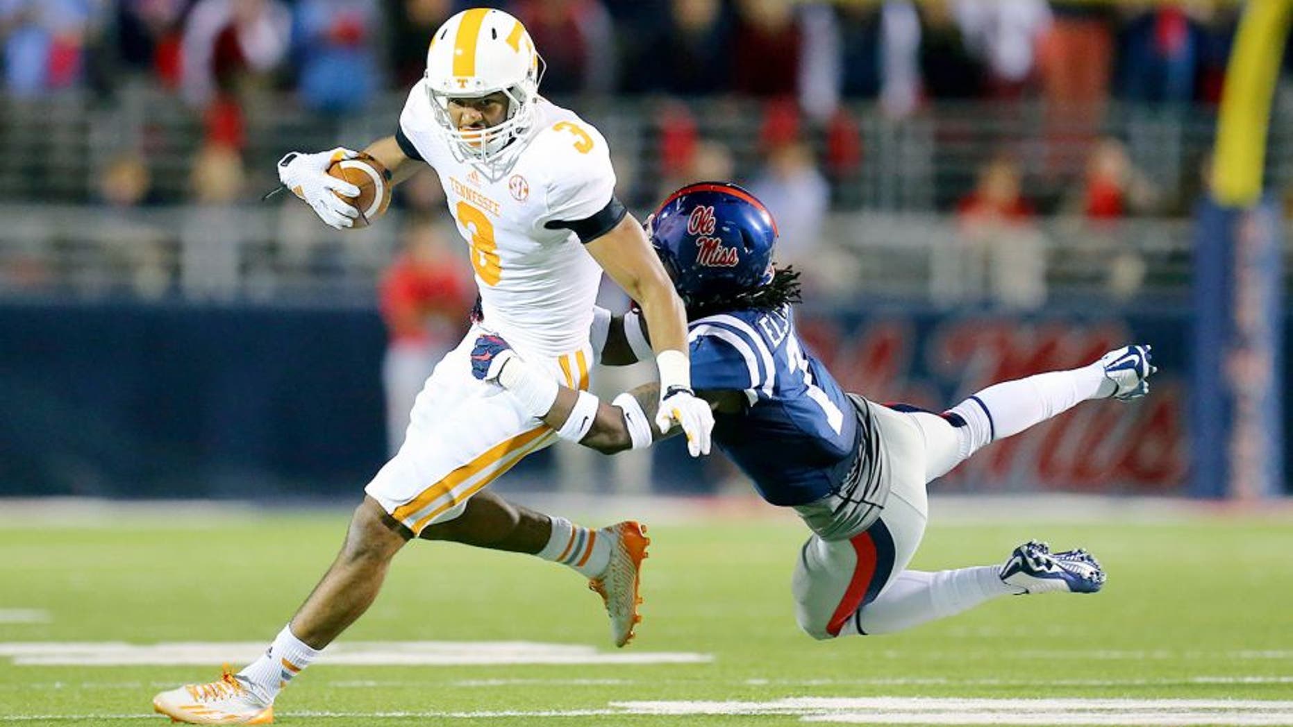 Oct 18, 2014; Oxford, MS, USA; Tennessee Volunteers wide receiver Josh Malone (3) is tackled by Mississippi Rebels defensive back Trae Elston (7) during the game at Vaught-Hemingway Stadium. The Mississippi Rebels defeated the Tennessee Volunteers 34-3. Mandatory Credit: Spruce Derden-USA TODAY Sports
