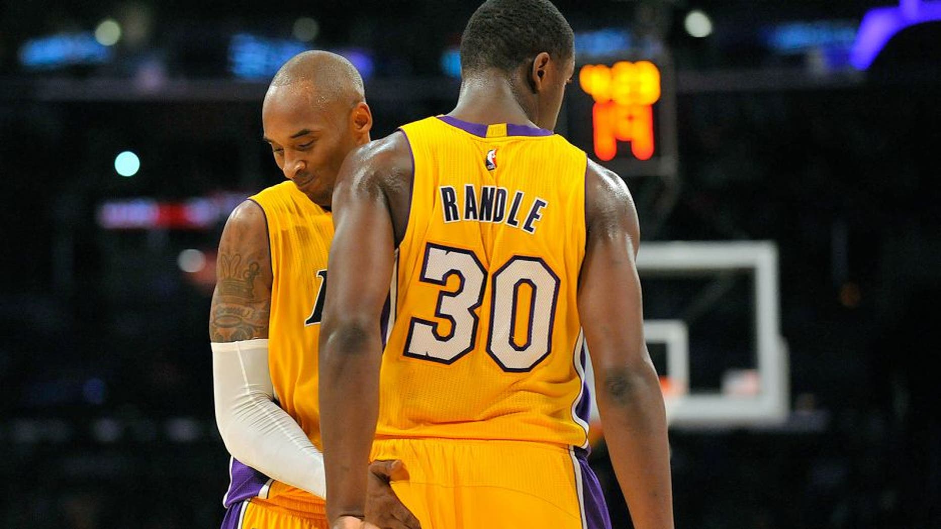 October 19, 2014; Los Angeles, CA, USA; Los Angeles Lakers guard Kobe Bryant (24) reacts with forward Julius Randle (30) after a foul is drawn against the Utah Jazz during the second half at Staples Center. Mandatory Credit: Gary A. Vasquez-USA TODAY Sports