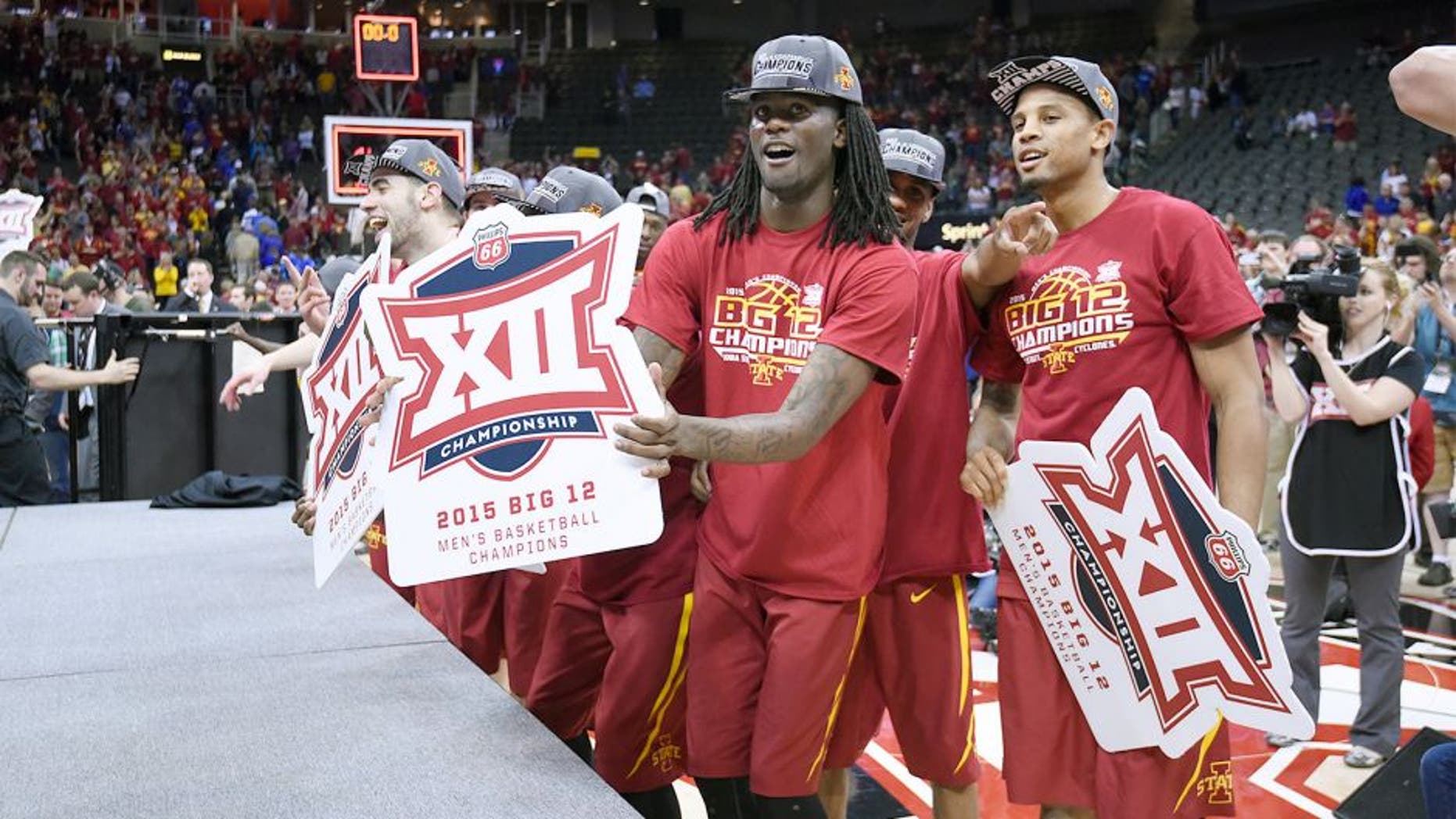 KANSAS CITY, MO - MARCH 14: Jameel McKay #1 and members of tof the Iowa State Cyclones celebrate after beating the Kansas Jayhawks during the championship game round of the Big 12 Basketball Tournament March 14, 2015 at Sprint Center in Kansas City, Missouri. (Photo by Ed Zurga/Getty Images)