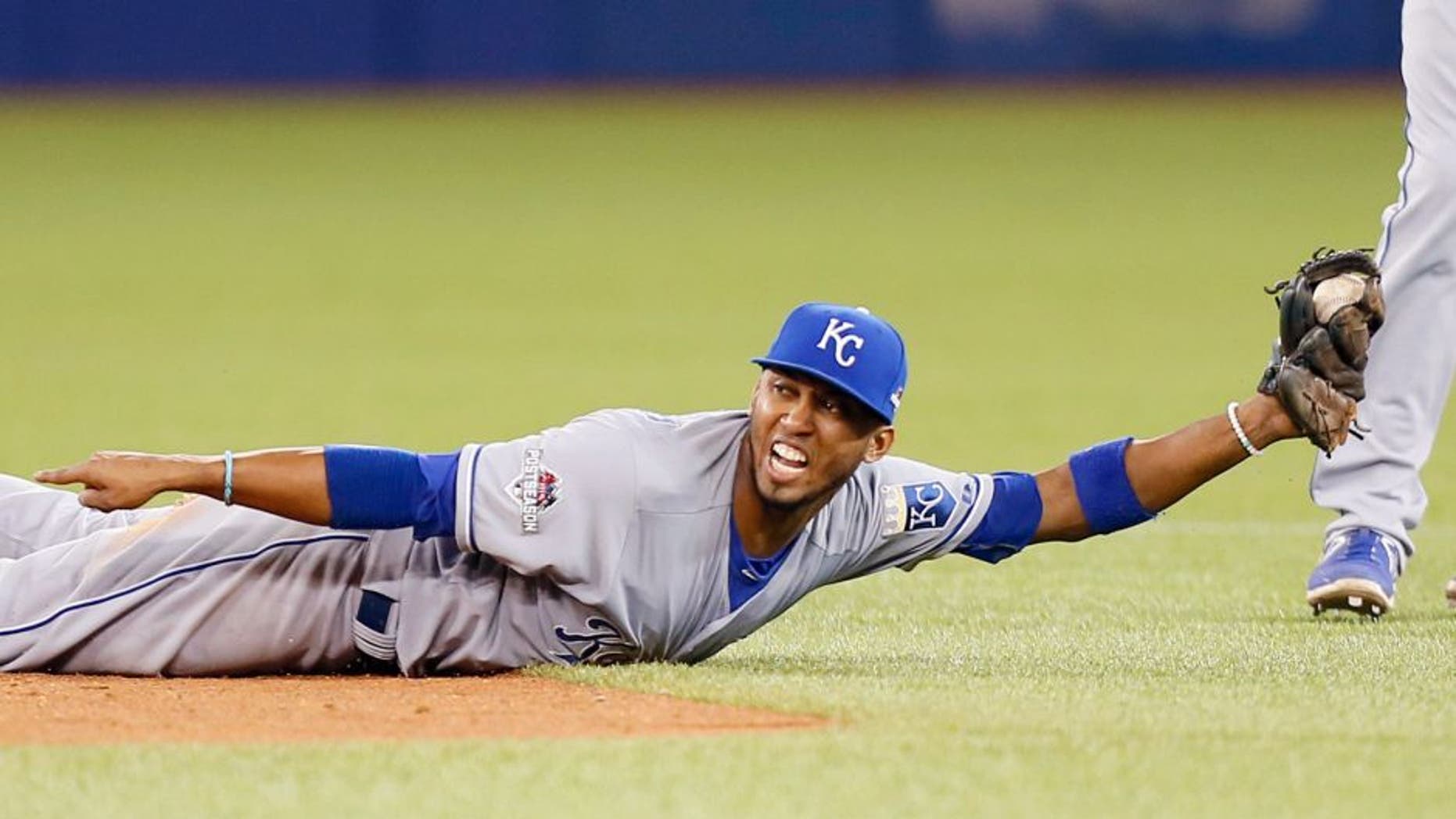 Oct 20, 2015; Toronto, Ontario, CAN; Kansas City Royals shortstop Alcides Escobar (2) dives and makes a force out during the seventh inning against the Toronto Blue Jays in game four of the ALCS at Rogers Centre. Mandatory Credit: John E. Sokolowski-USA TODAY Sports