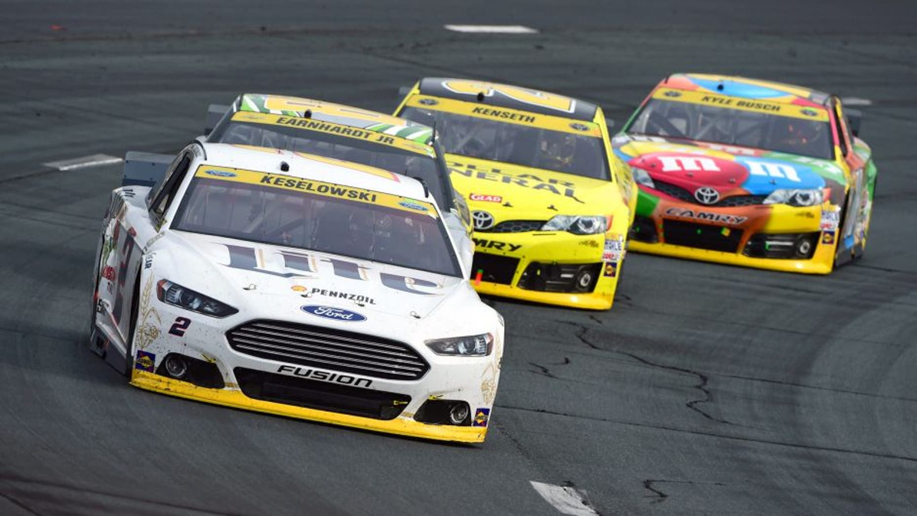 LOUDON, NH - SEPTEMBER 21: Brad Keselowski, driver of the #2 Miller Lite Ford, leads Dale Earnhardt Jr., driver of the #88 Diet Mountain Dew Chevrolet, Matt Kenseth, driver of the #20 Dollar General Toyota, and Kyle Busch, driver of the #18 M&M's Toyota, during the NASCAR Sprint Cup Series Sylvania 300 at New Hampshire Motor Speedway on September 21, 2014 in Loudon, New Hampshire. (Photo by Robert Laberge/NASCAR via Getty Images)