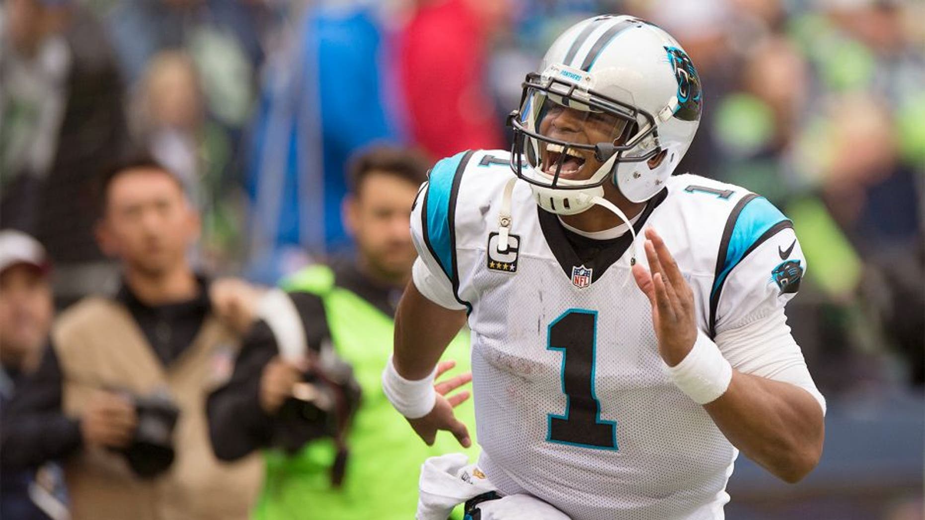 Oct 18, 2015; Seattle, WA, USA; Carolina Panthers quarterback Cam Newton (1) celebrates after throwing a game winning touchdown pass during the fourth quarter against the Seattle Seahawks at CenturyLink Field. The Panthers won 27-23. Mandatory Credit: Troy Wayrynen-USA TODAY Sports