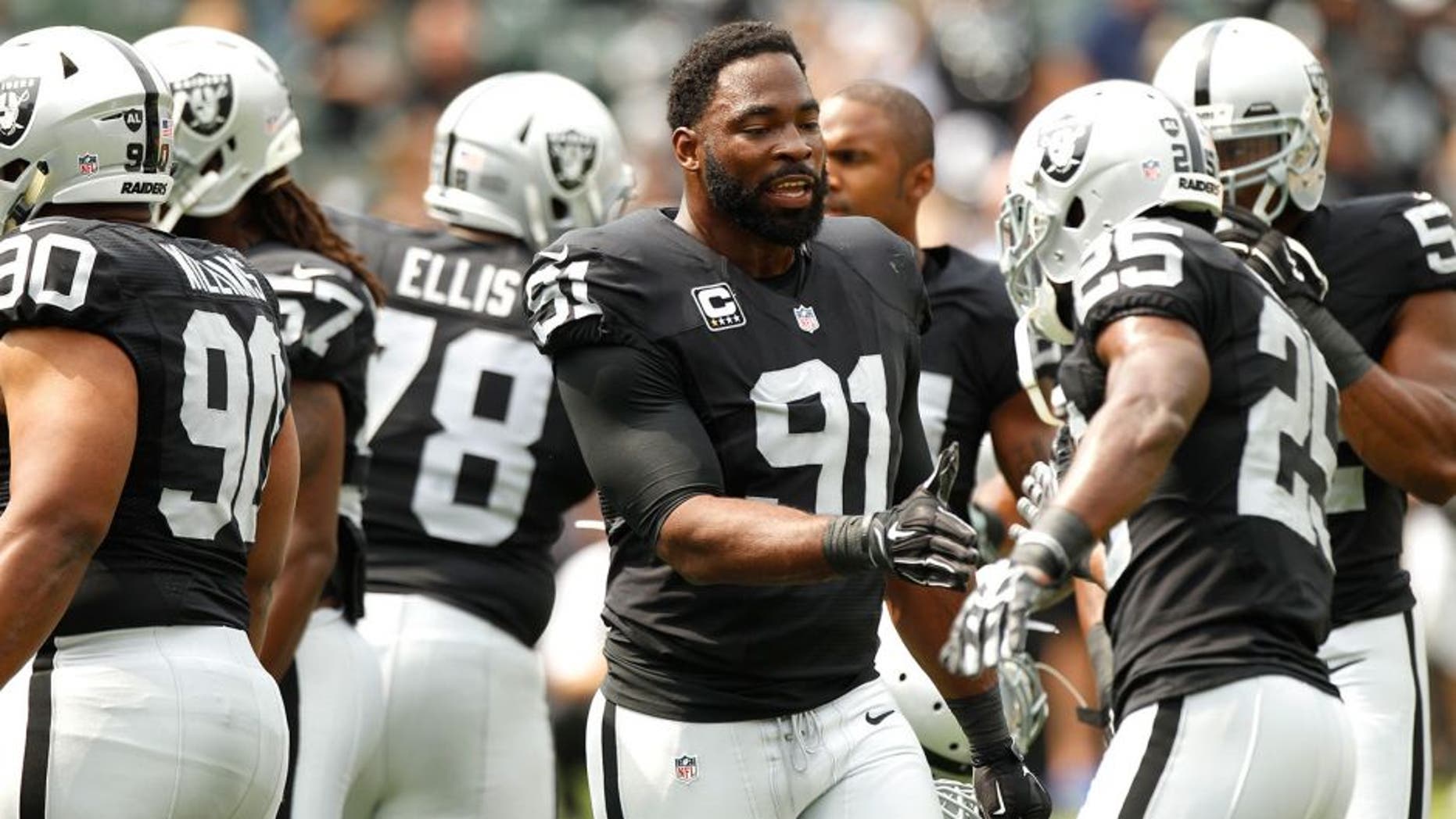 Sep 13, 2015; Oakland, CA, USA; Oakland Raiders defensive end Justin Tuck (91) talks with teammates before the start of the game against the Cincinnati Bengals at O.co Coliseum. Mandatory Credit: Cary Edmondson-USA TODAY Sports