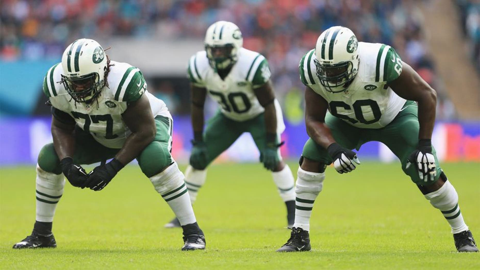 LONDON, ENGLAND - OCTOBER 04: James Carpenter #77 of the New York Jets, Darrin Walls #30 of the New York Jets and D'Brickashaw Ferguson #60 of the New York Jets wait at the line of scrimmage during the game against Miami Dolphins at Wembley Stadium on October 4, 2015 in London, England. (Photo by Stephen Pond/Getty Images)