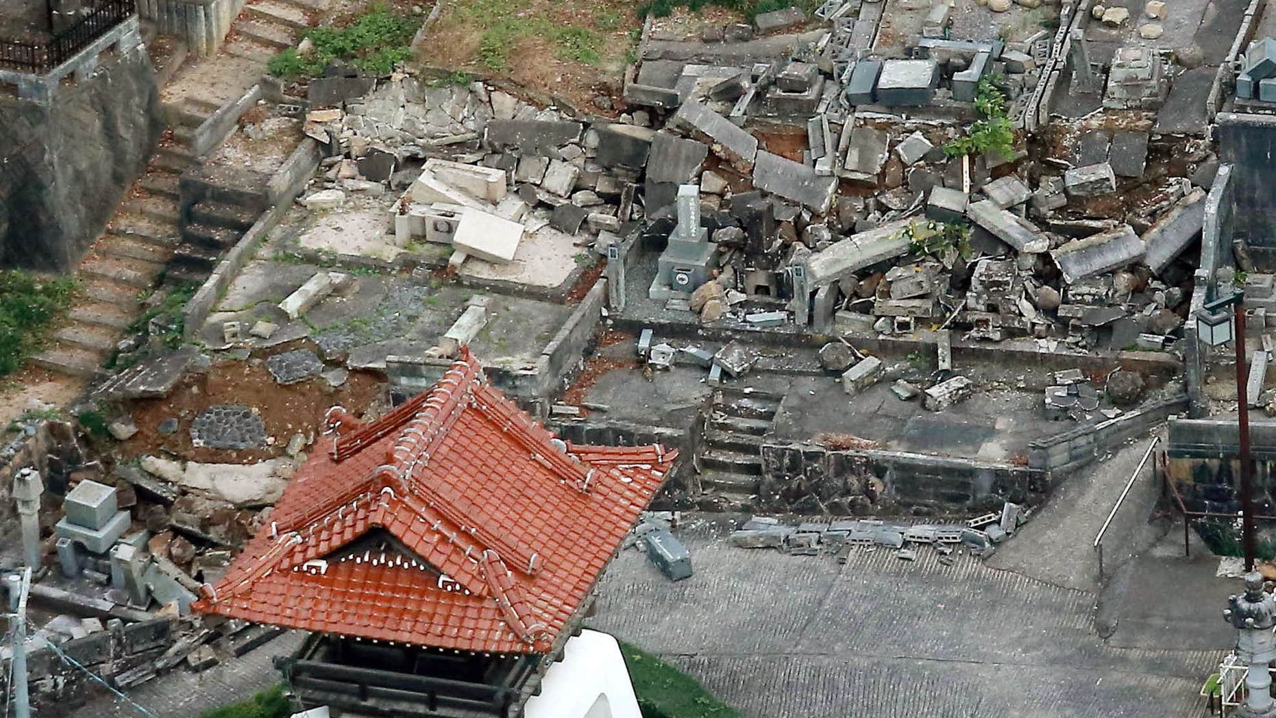 Oct. 21, 2016: This aerial photo shows fallen tomb stones scattered at a cemetery following an earthquake in Kurayoshi, Tottori prefecture.