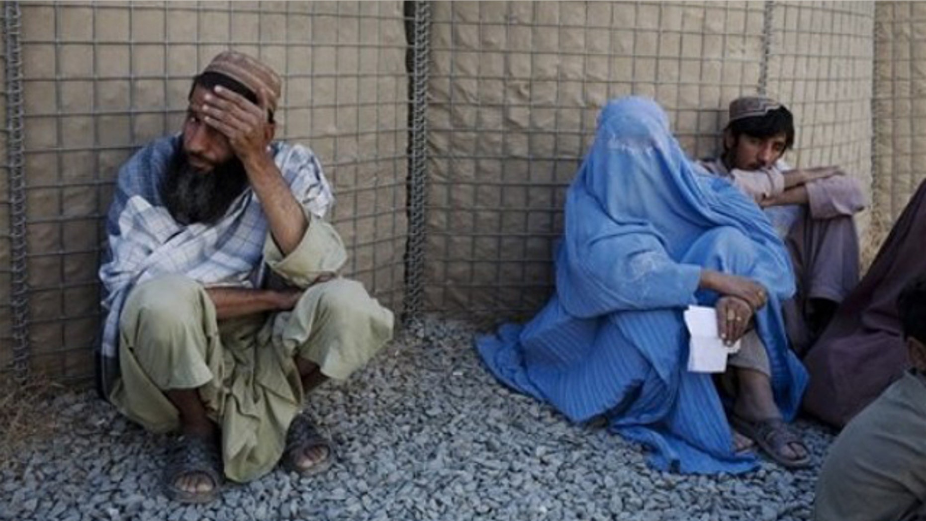 Oct. 20: Afghans wait to seek compensation for a relative's death outside Camp Nathan Smith, an ISAF military base in Kandahar City, Afghanistan.