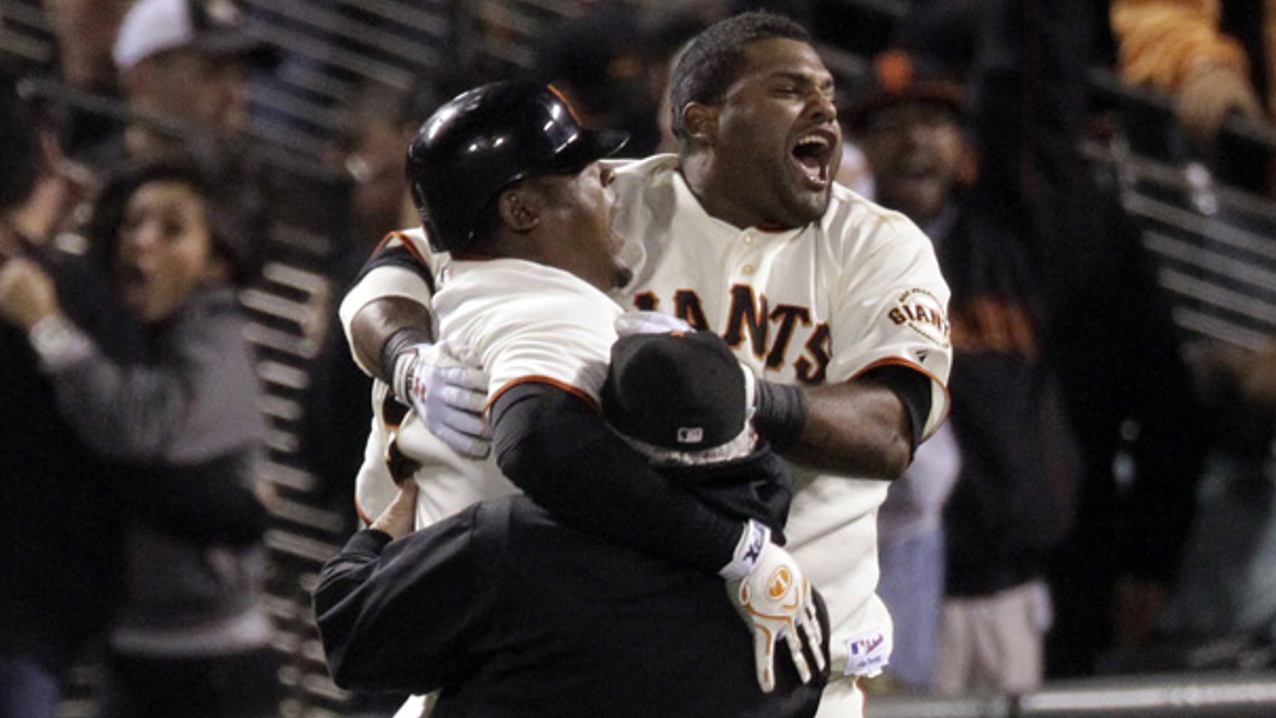 Oct. 20: San Francisco Giants' Juan Uribe, left, celebrates with Pablo Sandoval, right, after hitting a game-winning sacrifice fly during the ninth inning.