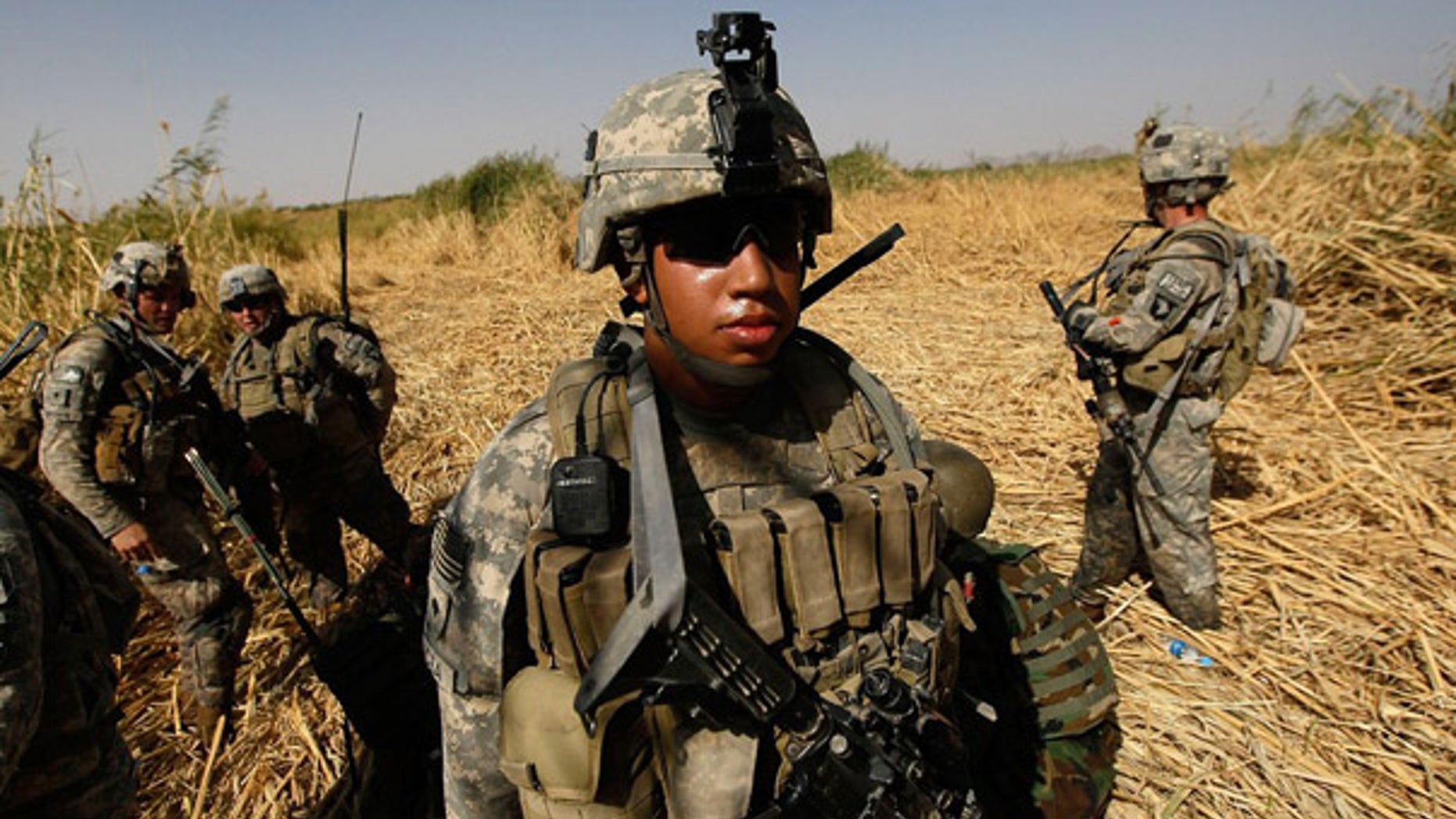 Oct. 15: U.S. Army soldiers march though tall grass and creeks to avoid buried bombs while on patrol near Kandahar.