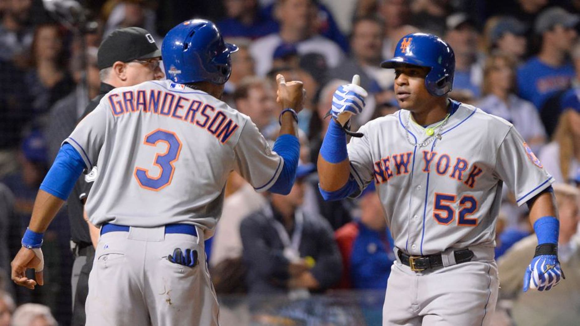 CHICAGO, IL - OCTOBER 21: Curtis Granderson #3 of the New York Mets and teammate Yoenis Cespedes #52 score on Lucas Duda's three-run home run in the top of the first inning of Game 4 of the NLCS against the Chicago Cubs at Wrigley Field on Wednesday, October 21, 2015 in Chicago, Illinois. (Photo by Ron Vesely/MLB Photos via Getty Images)