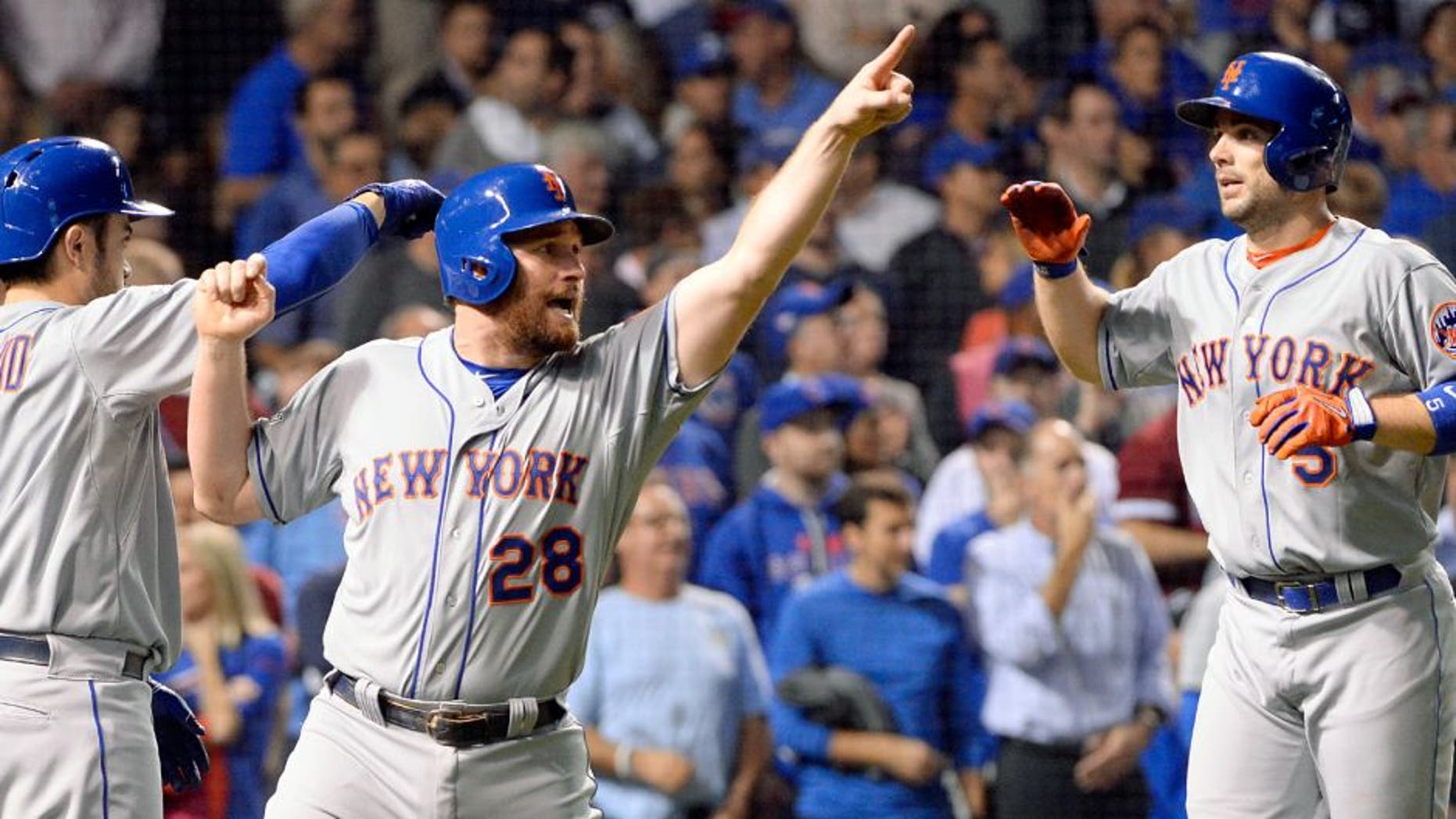 CHICAGO, IL - OCTOBER 21: Daniel Murphy #28 and David Wright #5 of the New York Mets celebrate after scoring on Lucas Duda's two-RBI double in the second inning of Game 4 of the NLCS against the Chicago Cubs at Wrigley Field on Wednesday, October 21, 2015 in Chicago, Illinois. (Photo by Ron Vesely/MLB Photos via Getty Images)