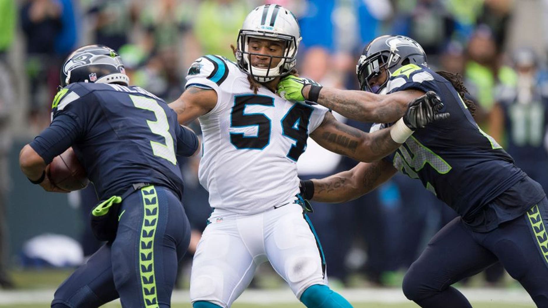 Oct 18, 2015; Seattle, WA, USA; Carolina Panthers linebacker Shaq Thompson (54) pursues Seattle Seahawks quarterback Russell Wilson (3) as running back Marshawn Lynch (24) blocks during the second half at CenturyLink Field. Lynch was called for holding on the play. The Panthers won 27-23. Mandatory Credit: Troy Wayrynen-USA TODAY Sports