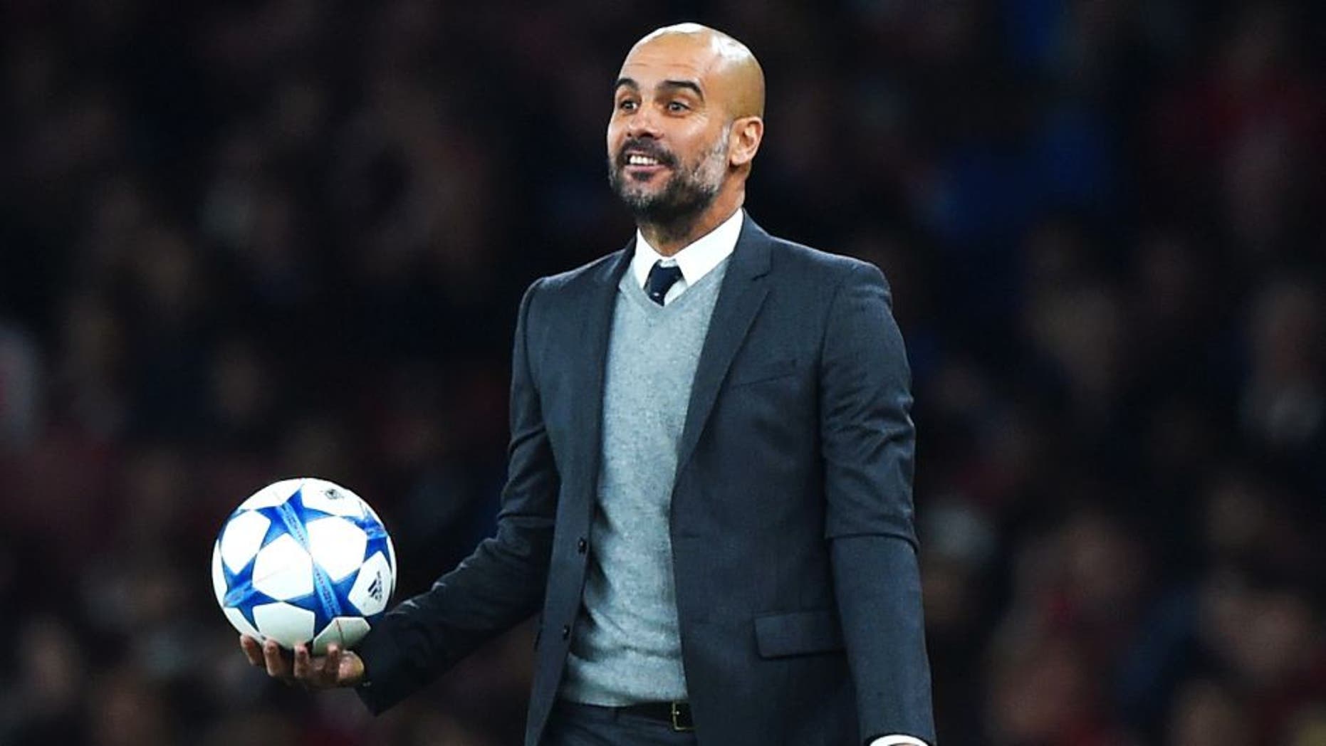 LONDON, ENGLAND - OCTOBER 20: Josep Guardiola manager of Bayern Munich reacts as he holds the match ball during the UEFA Champions League Group F match between Arsenal FC and FC Bayern Munchen at Emirates Stadium on October 20, 2015 in London, United Kingdom. (Photo by Shaun Botterill/Bongarts/Getty Images)