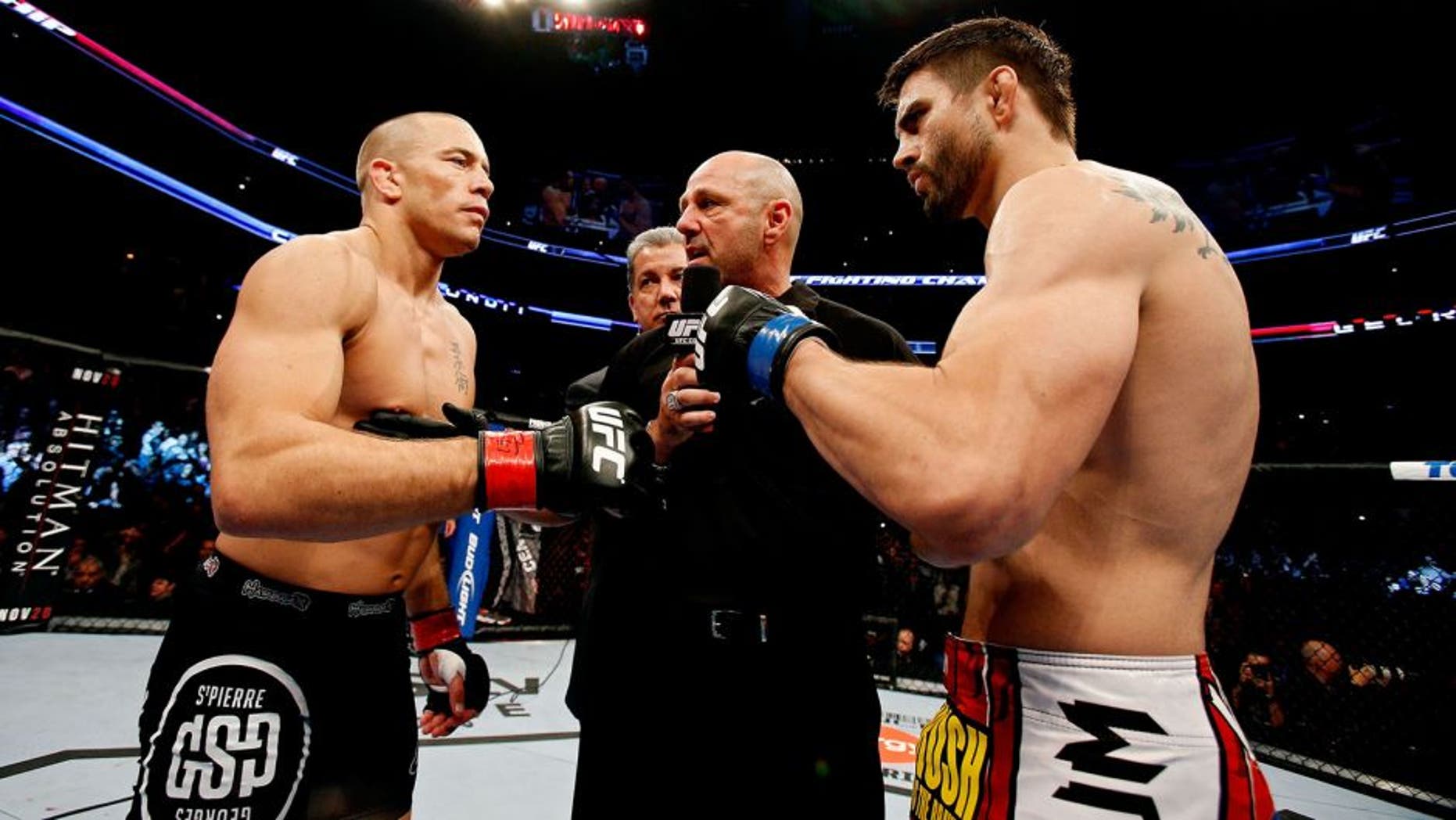 MONTREAL, QC - NOVEMBER 17: Carlos Condit (R) and Georges St-Pierre prepare to fight in their welterweight title bout during UFC 154 on November 17, 2012 at the Bell Centre in Montreal, Canada. (Photo by Josh Hedges/Zuffa LLC/Zuffa LLC via Getty Images)