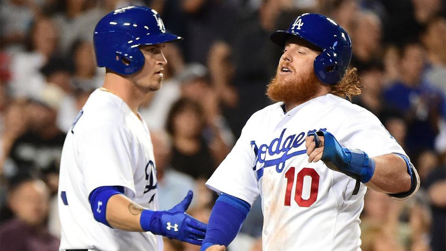 LOS ANGELES, CA - SEPTEMBER 02: Justin Turner #10 of the Los Angeles Dodgers celebrates his run with Yasmani Grandal #9 to take a 1-0 lead over the San Francisco Giants during the second inning at Dodger Stadium on September 2, 2015 in Los Angeles, California. (Photo by Harry How/Getty Images)