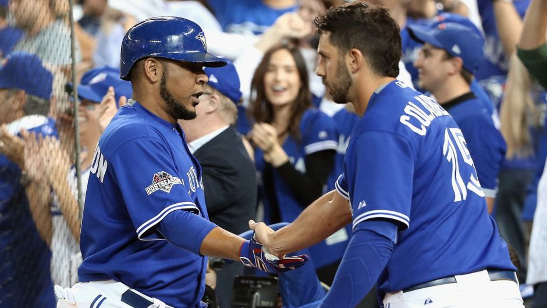 TORONTO, ON - OCTOBER 21: Edwin Encarnacion #10 of the Toronto Blue Jays is congratulated by Chris Colabello #15 of the Toronto Blue Jays after scoring a run in the sixth inning against the Kansas City Royals during game five of the American League Championship Series at Rogers Centre on October 21, 2015 in Toronto, Canada. (Photo by Tom Szczerbowski/Getty Images)