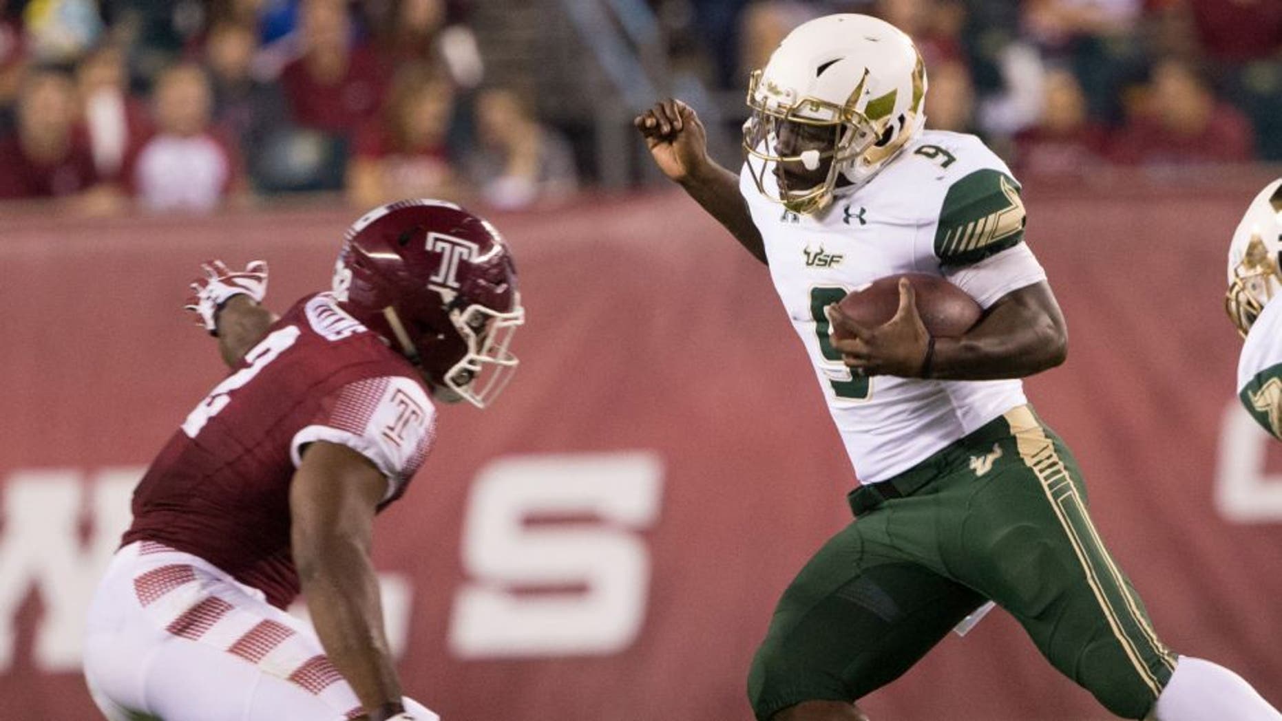 Oct 21, 2016; Philadelphia, PA, USA; South Florida Bulls quarterback Quinton Flowers (9) carrie the ball past Temple Owls linebacker Avery Williams (2) during the first quarter at Lincoln Financial Field. Mandatory Credit: Bill Streicher-USA TODAY Sports