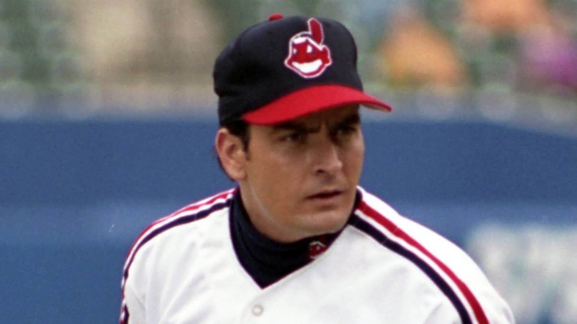 BALTIMORE, MD - SEPTEMBER, 1993: Actor Charlie Sheen as Rick Wild Thing Vaughn #99 of the Cleveland Indians gets the sign for the next pitch from the catcher during the filming of the motion picture "Major League II" in September, 1993 at Camden Yards in Baltimore, Maryland. (Photo by: Diamond Images/Getty Images)