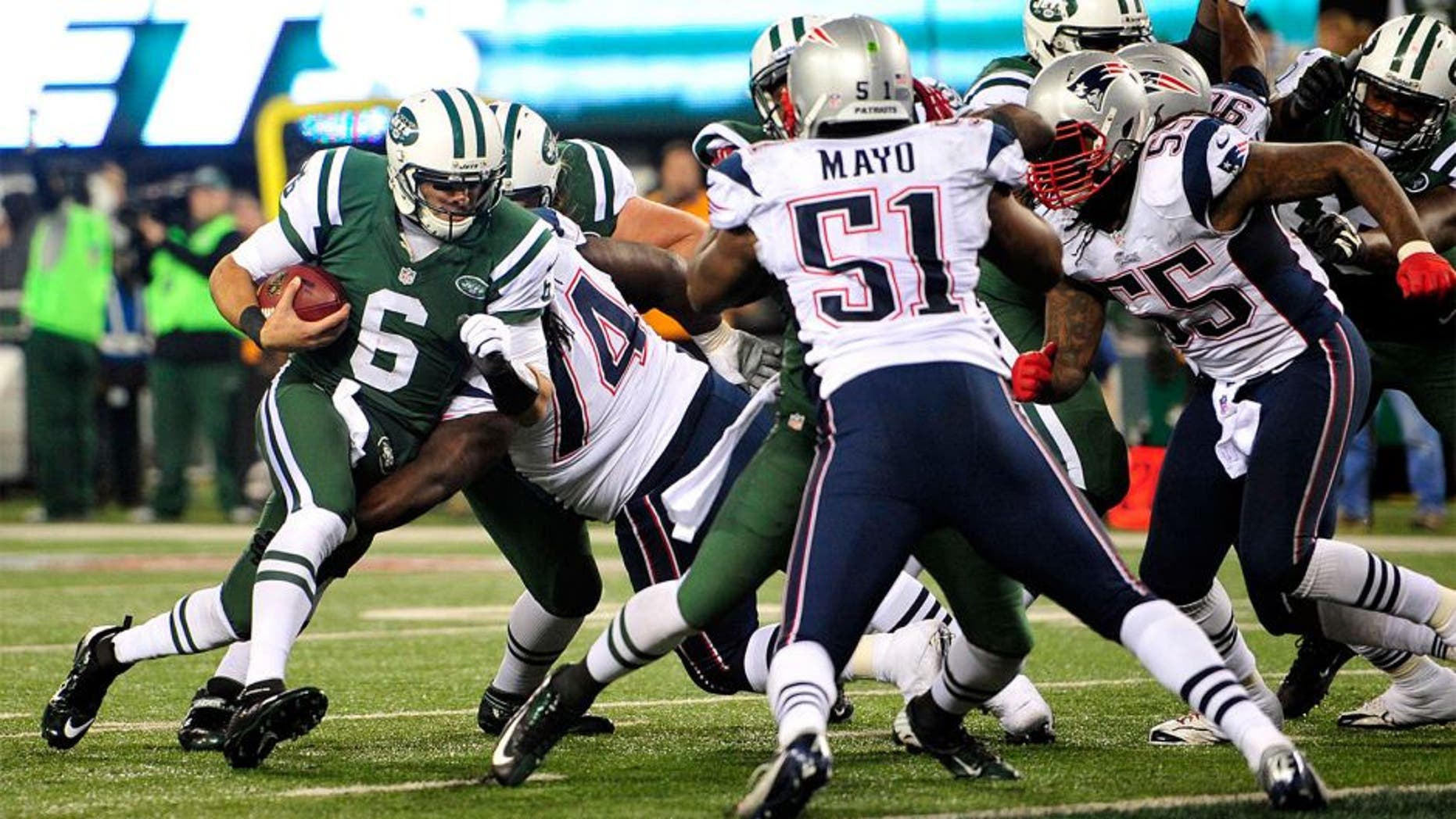 Nov 22, 2012; East Rutherford, NJ, USA; New York Jets quarterback Mark Sanchez (6) runs against the New England Patriots during the second half on Thanksgiving at Metlife Stadium. Mandatory Credit: Joe Camporeale-USA TODAY Sports