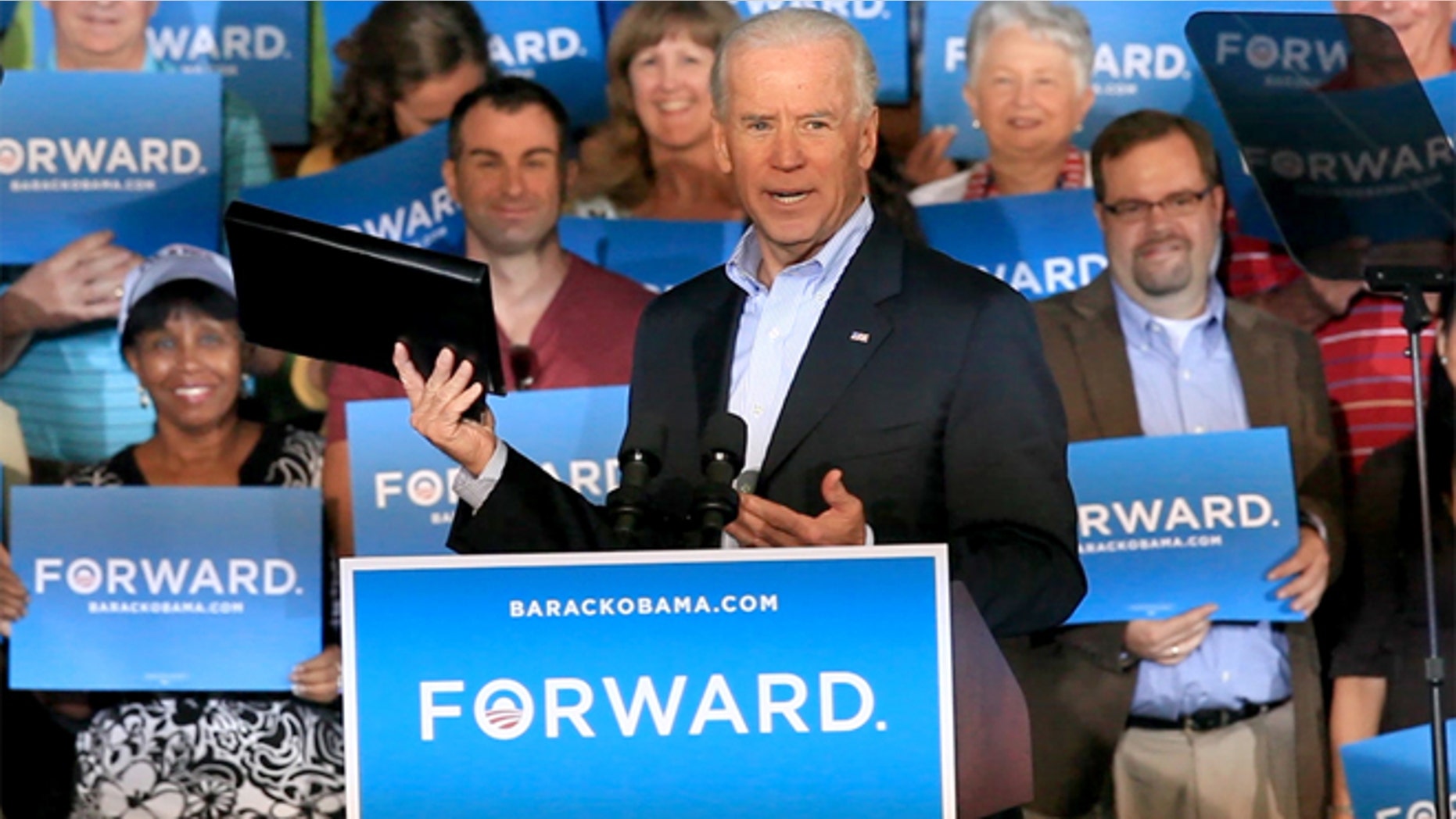 Oct. 20, 2012: Vice President Joe Biden holds up a binder while remarking on Republican presidential candidate Mitt Romney's recent debate gaffe during a visit to Ketterlinus Gymnasium in St. Augustine, Fla.
