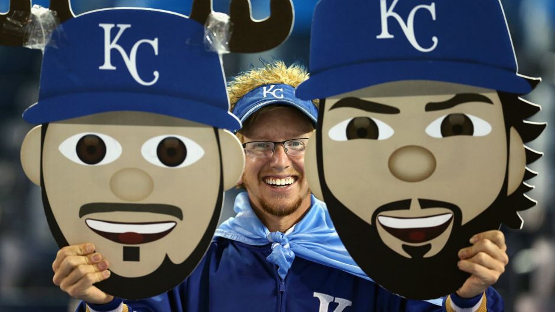 TORONTO, ON - OCTOBER 21: A Kansas City Royals fan holds up signs prior to game five of the American League Championship Series between the Toronto Blue Jays and the Kansas City Royals at Rogers Centre on October 21, 2015 in Toronto, Canada. (Photo by Vaughn Ridley/Getty Images)