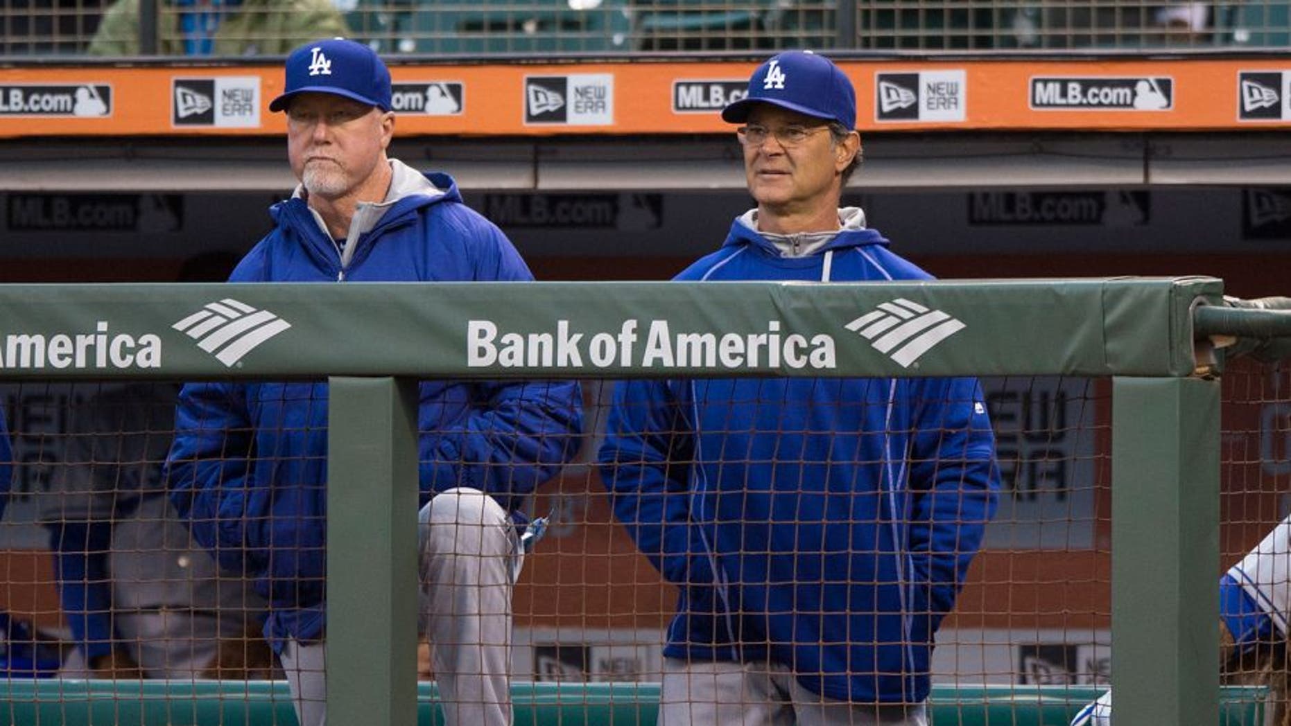 SAN FRANCISCO, CA - APRIL 21: Mark McGwire #25 of the Los Angeles Dodgers and manager Don Mattingly #8 stand in the dugout during the first inning against the San Francisco Giants at AT&T Park on April 21, 2015 in San Francisco, California. The San Francisco Giants defeated the Los Angeles Dodgers 6-2. (Photo by Jason O. Watson/Getty Images)