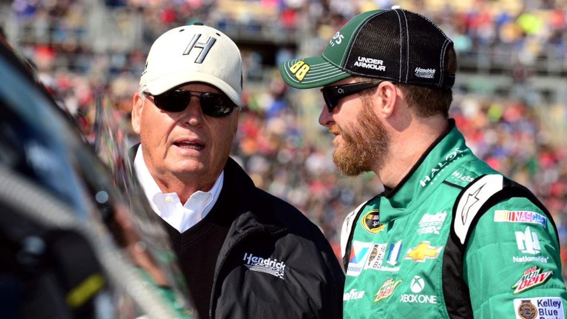 KANSAS CITY, KS - OCTOBER 18: Dale Earnhardt Jr., driver of the #88 Halo 5: Master Chief Chevrolet, talks with Rick Hendrick, owner of Hendrick Motorsports, on the grid prior to the NASCAR Sprint Cup Series Hollywood Casino 400 at Kansas Speedway on October 18, 2015 in Kansas City, Kansas. (Photo by Jeff Curry/Getty Images)