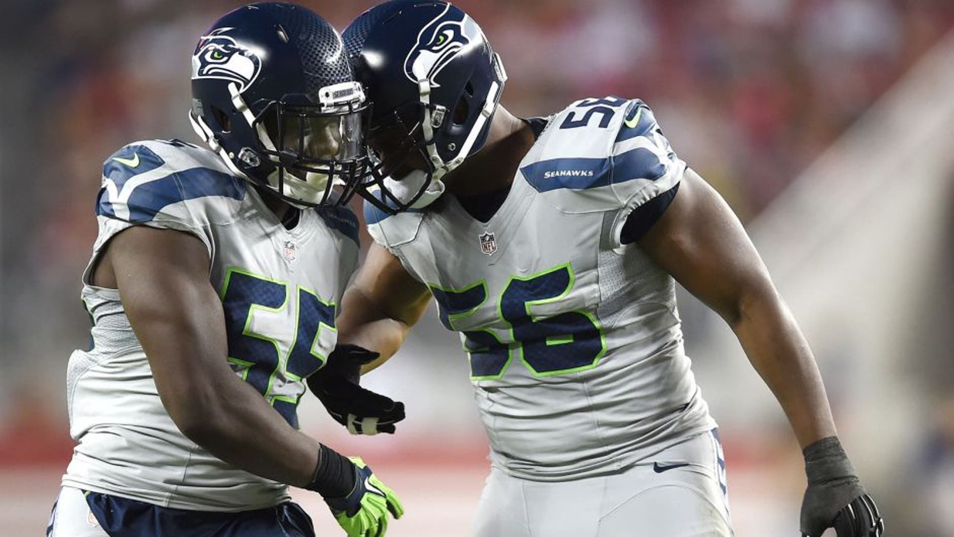 SANTA CLARA, CA - OCTOBER 22: Frank Clark #55 and Cliff Avril #56 of the Seattle Seahawks react after a sack on Colin Kaepernick #7 of the San Francisco 49ers during their NFL game at Levi's Stadium on October 22, 2015 in Santa Clara, California. (Photo by Thearon W. Henderson/Getty Images)