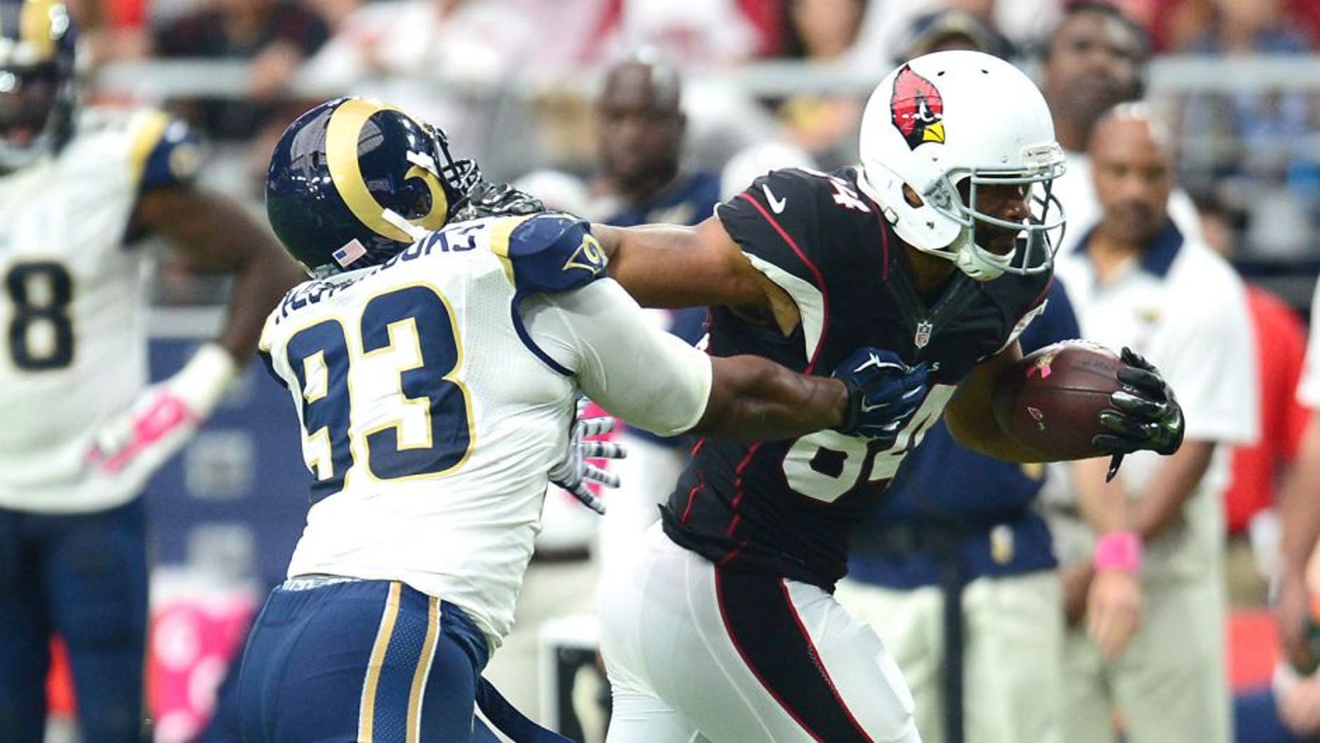 Oct 4, 2015; Glendale, AZ, USA; Arizona Cardinals tight end Jermaine Gresham (84) stiff arms St. Louis Rams defensive tackle Ethan Westbrooks (93) during the second half at University of Phoenix Stadium. The Rams won 24-22. Mandatory Credit: Joe Camporeale-USA TODAY Sports