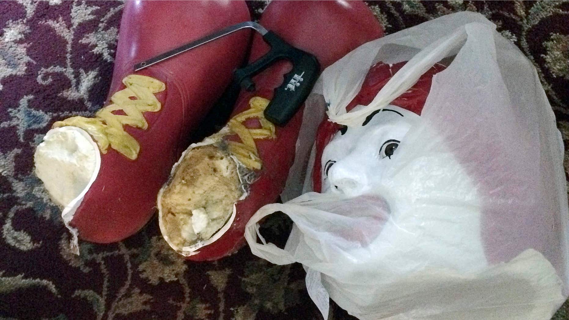 Oct. 22, 2015: This photo provided by Ronald McDonald House Charities, shows the decapitated head and feet from the Ronald McDonald statue that sits on a bench outside the Ronald McDonald House in Burlington, Vt.