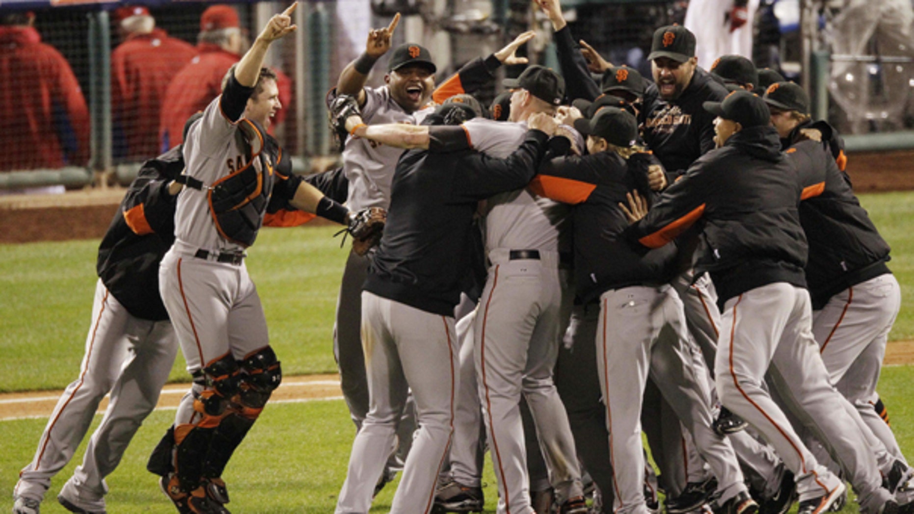Oct. 23: The San Francisco Giants celebrate after the ninth inning of Game 6 of baseball's National League Championship Series against the Philadelphia Phillies in Philadelphia.