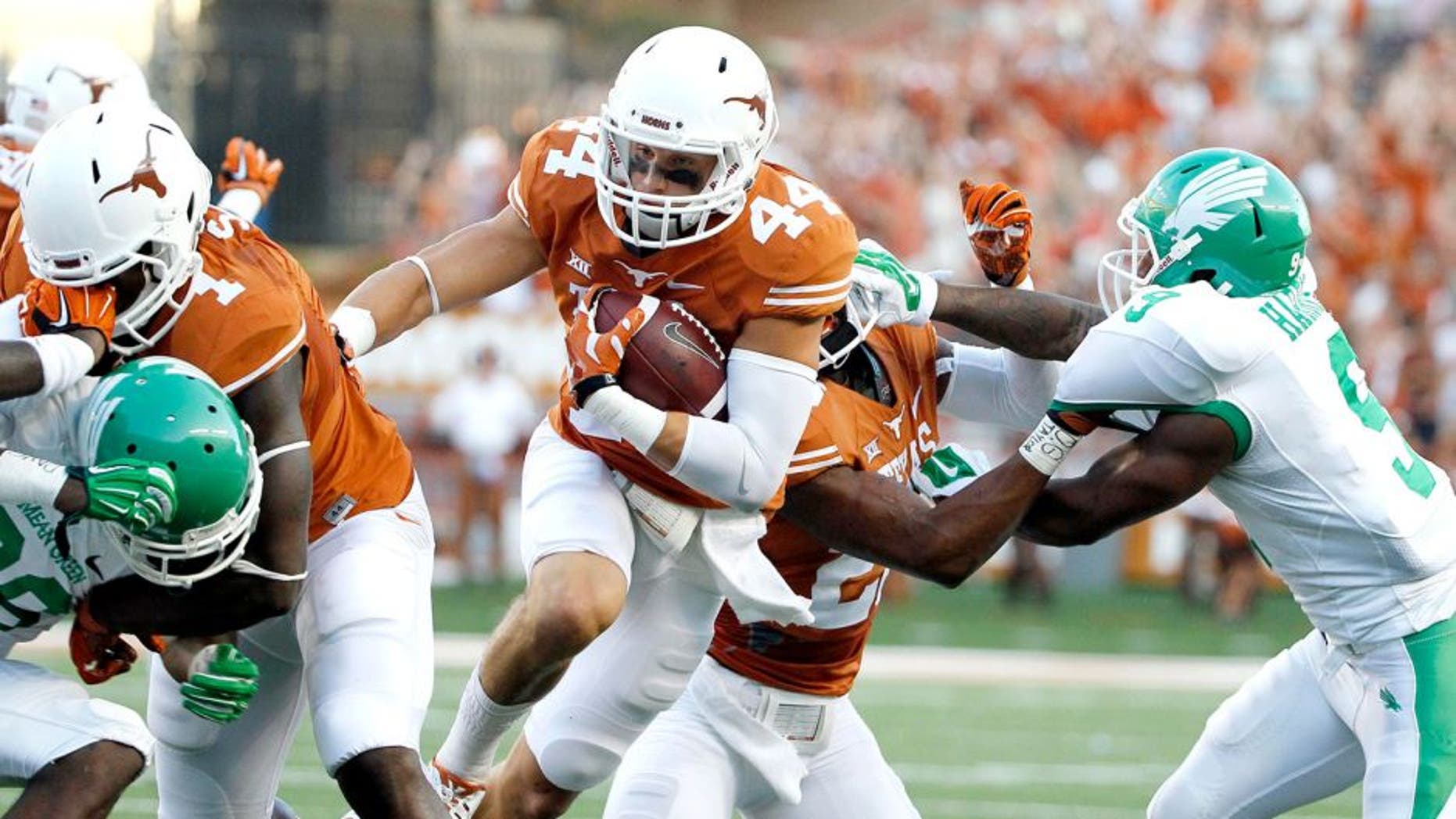 Aug 30, 2014; Austin, TX, USA; Texas Longhorns defensive back Dylan Haines (44) run with the ball after an interception against the North Texas Mean Green during the first half at Darrell K Royal-Texas Memorial Stadium. Mandatory Credit: Soobum Im-USA TODAY Sports