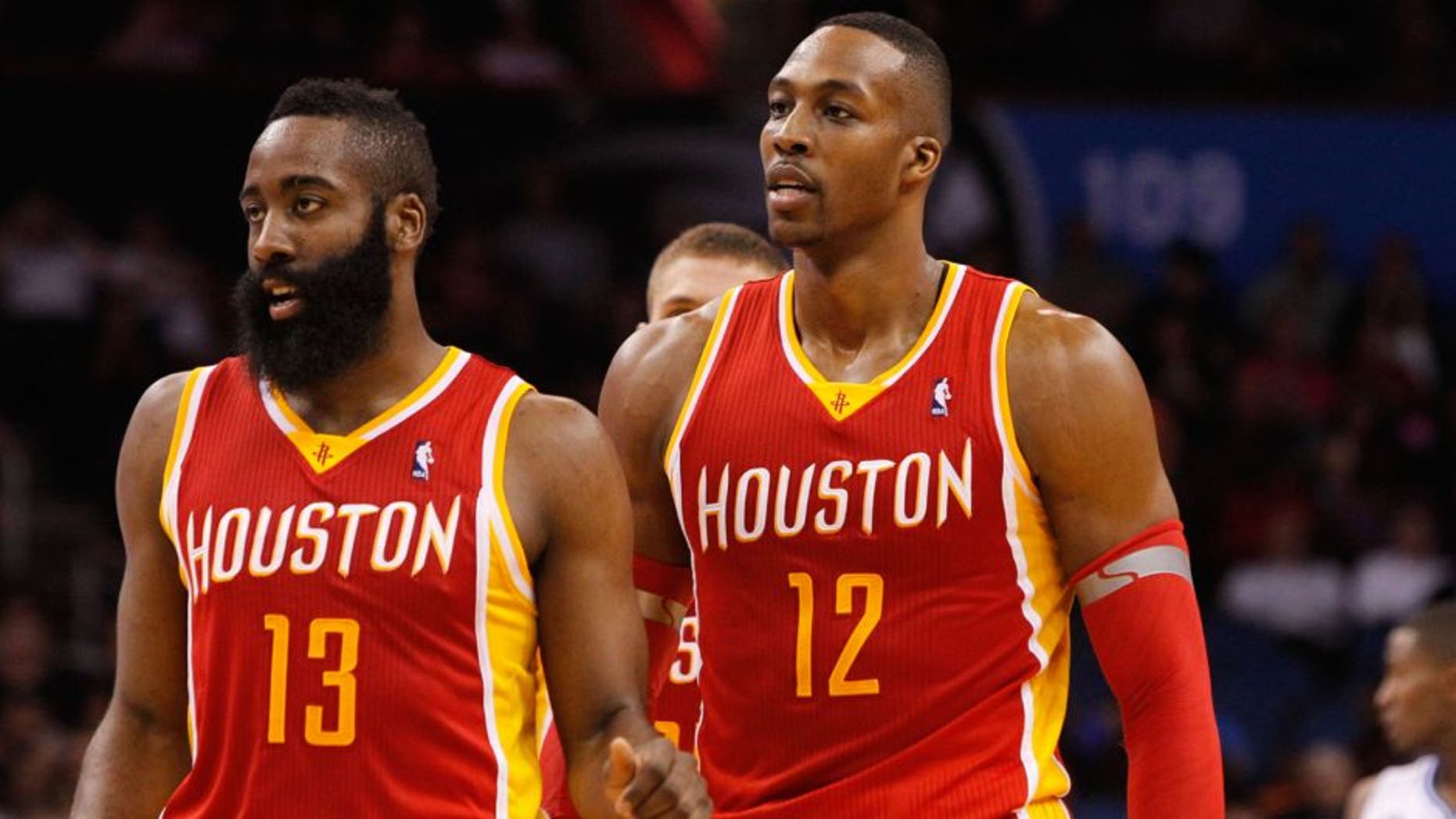 Mar 5, 2014; Orlando, FL, USA; Houston Rockets shooting guard James Harden (13) and Houston Rockets center Dwight Howard (12) against the Orlando Magic during the second half at Amway Center. Houston Rockets defeated the Orlando Magic 101-89. Mandatory Credit: Kim Klement-USA TODAY Sports