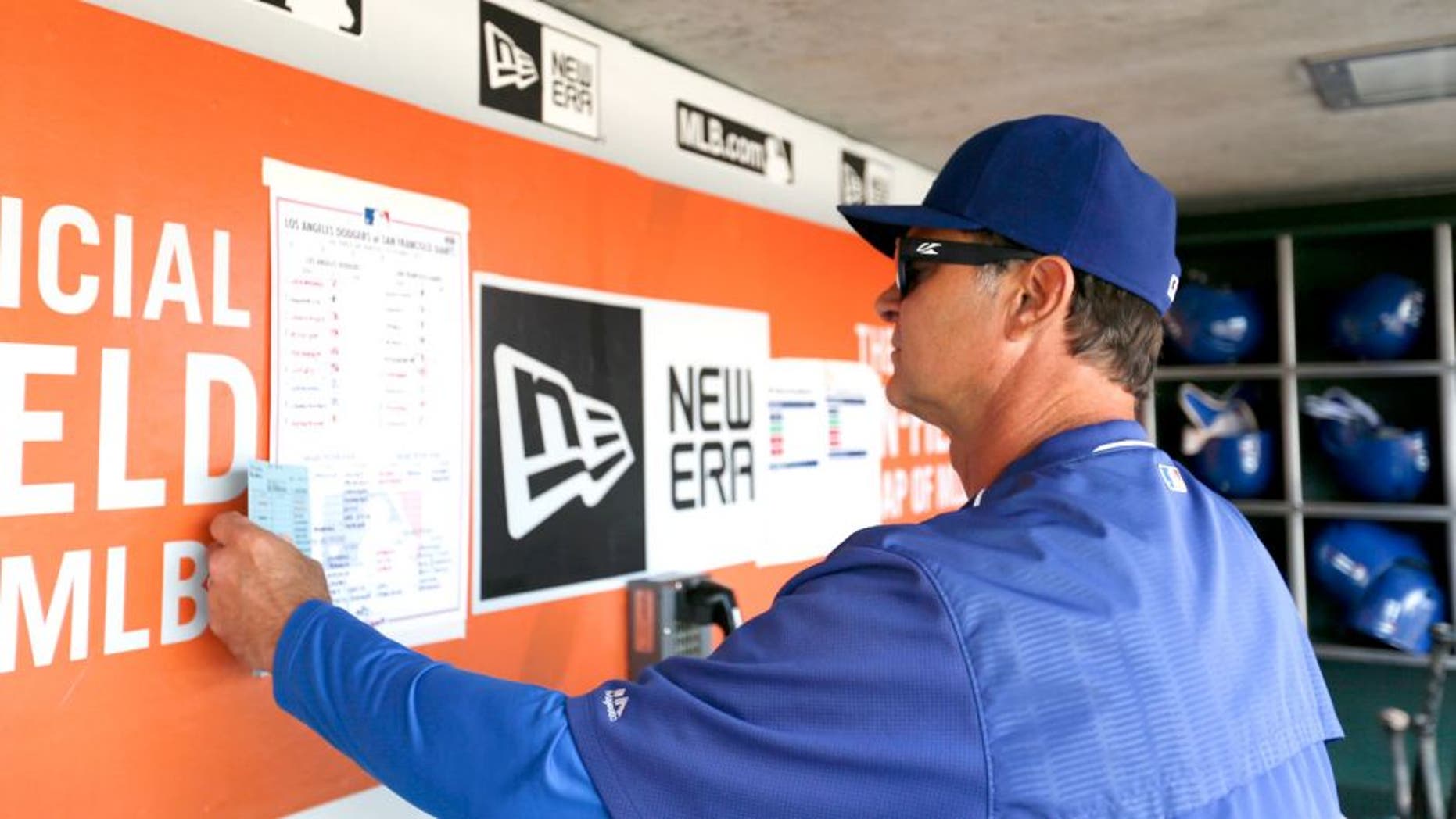 SAN FRANCISCO, CA - OCTOBER 1: Manager Don Mattingly #8 of the Los Angeles Dodgers checks the lineup in the dugout prior to the game against theSan Francisco Giants at AT&T Park on October 1, 2015 in San Francisco, California. The Dodgers defeated the Giants 3-2. (Photo by Michael Zagaris/Getty Images)