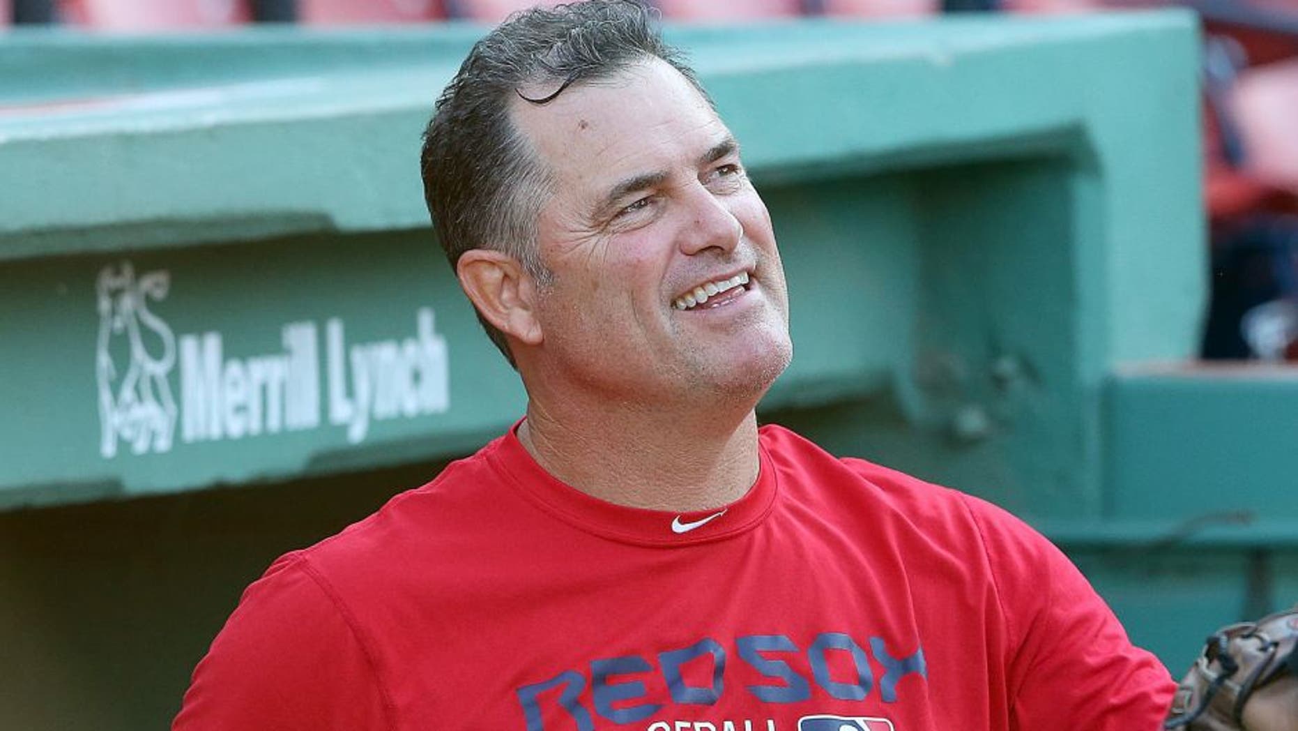 BOSTON, MA - AUGUST 19: John Farrell #53 of the Boston Red Sox makes a visit to the dugout before a game against the Cleveland Indians at Fenway Park on August 19, 2015 in Boston, Massachusetts. Last week, Farrell relinquished his duties as manager to undergo treatment for lymphoma. (Photo by Jim Rogash/Getty Images)