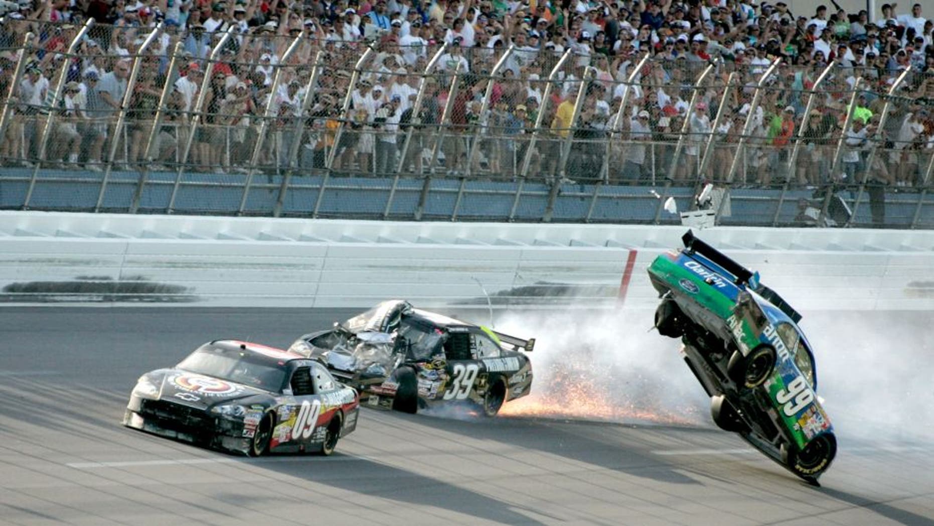 TALLADEGA, AL - APRIL 26: Carl Edwards, driver of the #99 Claritin Ford, goes airborne as Ryan Newman, driver of the #39 Steweart-Haas Racing Chevrolet suffers damage and Dale Earnhardt Jr., driver of the #88 National Guard / AMP Energy Chevrolet drives at the conclusion of the NASCAR Sprint Cup Series Aaron's 499 at Talladega Superspeedway on April 26, 2009 in Talladega, Alabama. (Photo by Jerry Markland/Getty Images for NASCAR) *** Local Caption *** Carl Edards;Ryan Edwards;Dale Earnhardt Jr.