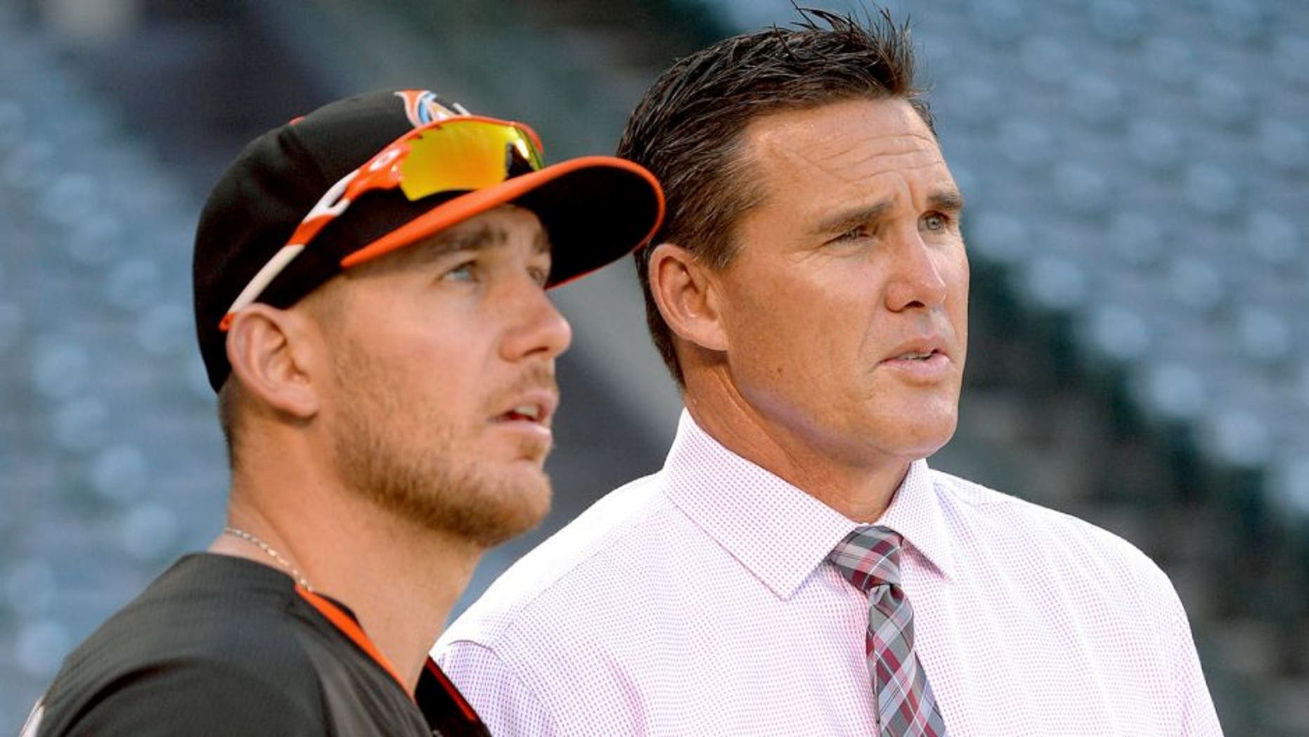 ANAHEIM, CA - AUGUST 26: Jeff Mathis #6 of the Miami Marlins talks to assistant general manager Scott Servais of the Los Angeles Angels of Anaheim before the game on August 26, 2014 at Angel Stadium of Anaheim in Anaheim, California. (Photo by Matt Brown/Angels Baseball LP/Getty Images)