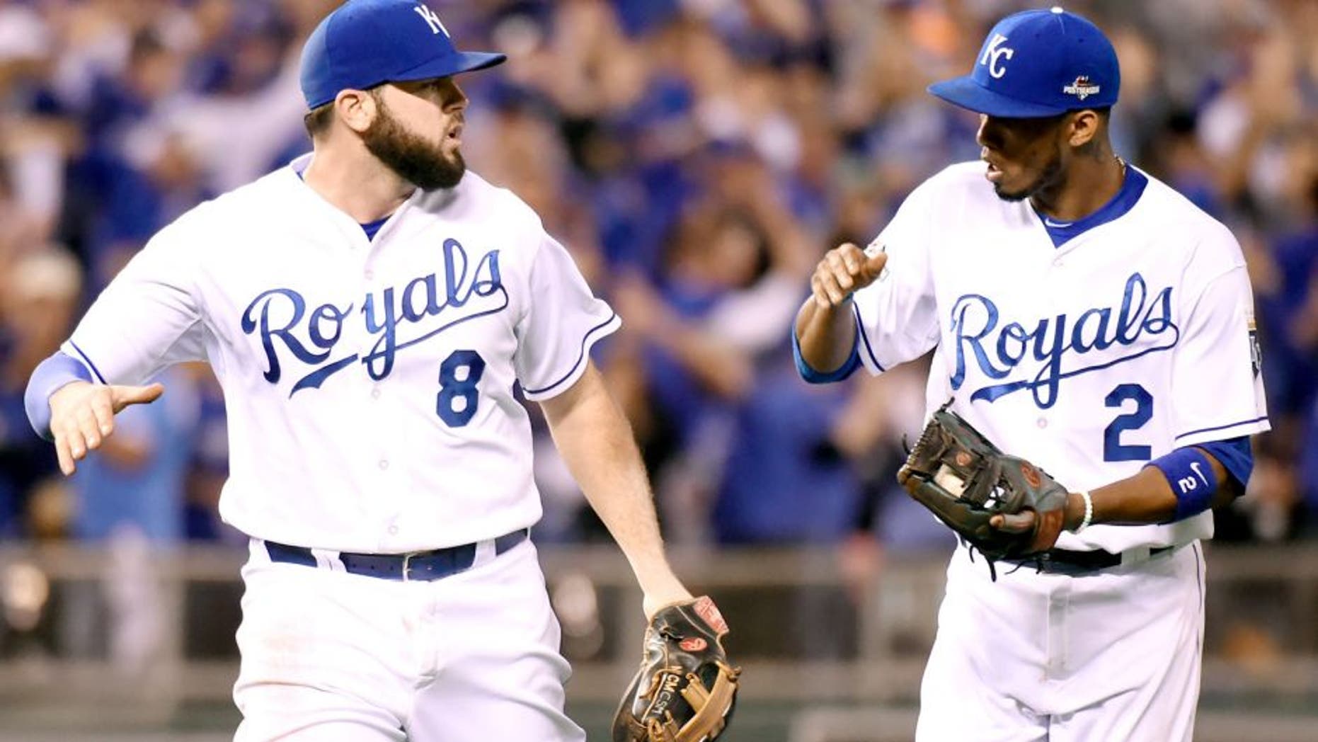 KANSAS CITY, MO - OCTOBER 23: Mike Moustakas #8 and Alcides Escobar #2 of the Kansas City Royals celebrate the end of an inning during Game 6 of the ALCS against the Toronto Blue Jays at Kauffman Stadium on Friday, October 23, 2015 in Kansas City Missouri. (Photo by LG Patterson/MLB Photos via Getty Images)