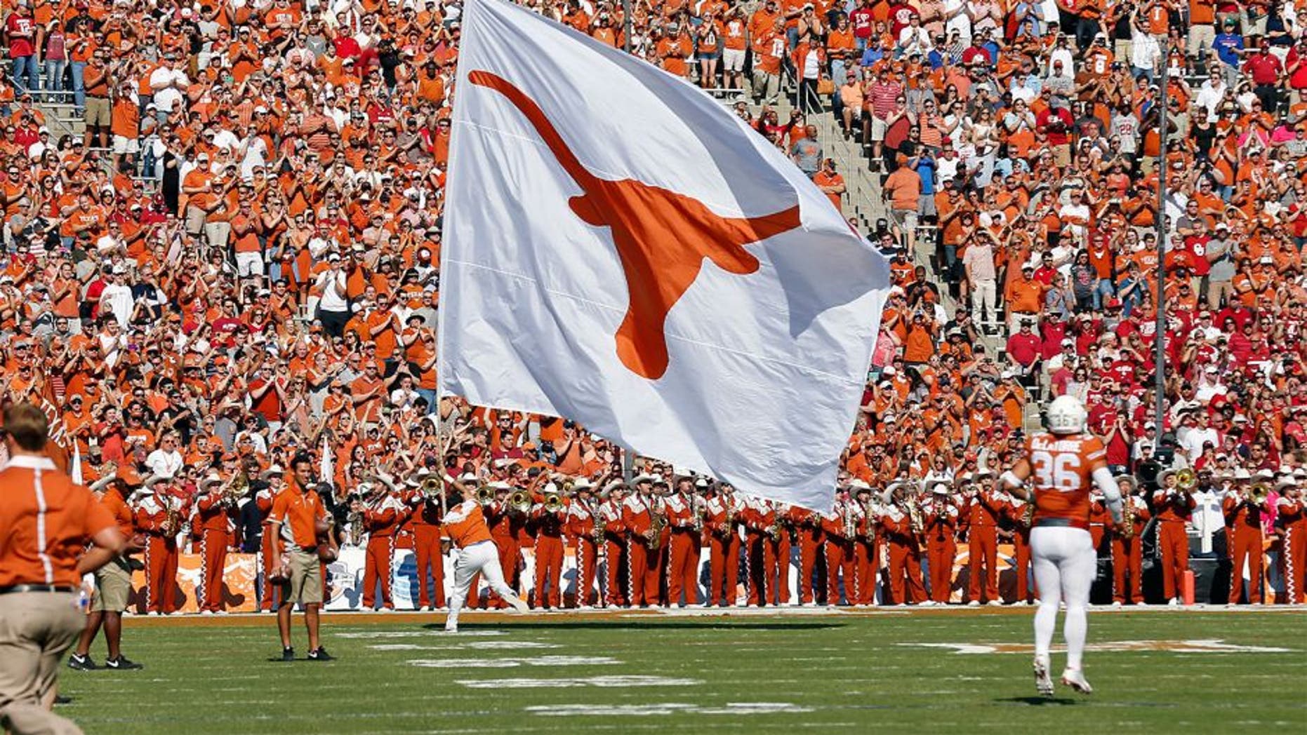 Oct 10, 2015; Dallas, TX, USA; Texas Longhorns cheerleader carries a Texas flag against the Oklahoma Sooners during Red River rivalry at Cotton Bowl Stadium. Mandatory Credit: Matthew Emmons-USA TODAY Sports