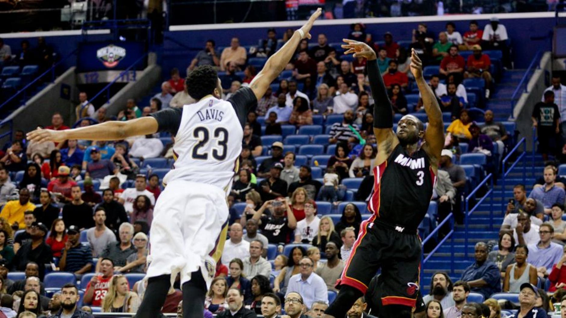 Oct 23, 2015; New Orleans, LA, USA; Miami Heat guard Dwyane Wade (3) shoots over New Orleans Pelicans forward Anthony Davis (23) during the second quarter of a game at the Smoothie King Center. Mandatory Credit: Derick E. Hingle-USA TODAY Sports