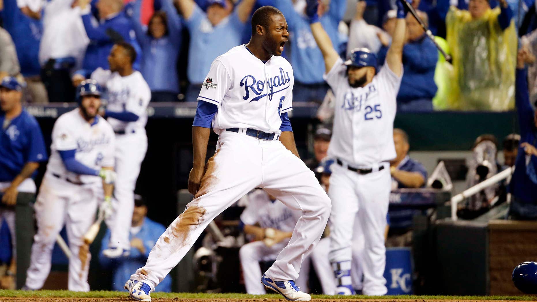 Kansas City Royals' Lorenzo Cain celebrates after scoring on a hit by Eric Hosmer against the Toronto Blue Jays during the eight inning in Game 6 of baseball's American League Championship Series on Friday, Oct. 23, 2015, in Kansas City, Mo.