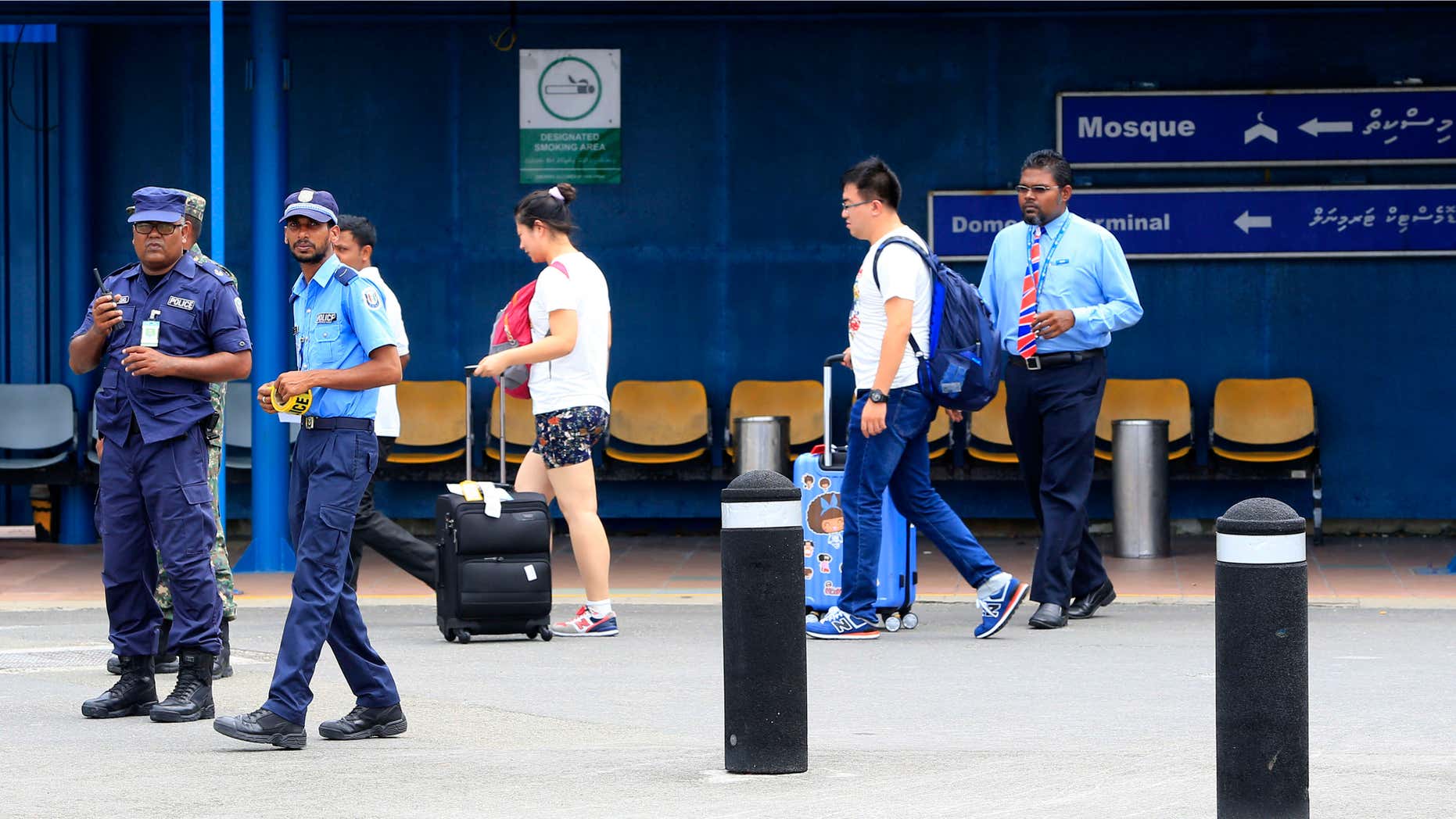 Oct. 24, 2015: Police prepare to cordon off an area before the arrival of Vice President Ahmed Adheeb at the International Airport in Male, Maldives.