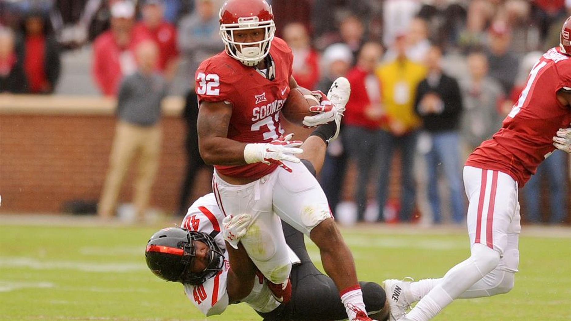Oct 24, 2015; Norman, OK, USA; Oklahoma Sooners running back Samaje Perine (32) runs through a tackle attempt by Texas Tech Red Raiders linebacker Dakota Allen (40) during the second quarter at Gaylord Family - Oklahoma Memorial Stadium. Mandatory Credit: Mark D. Smith-USA TODAY Sports