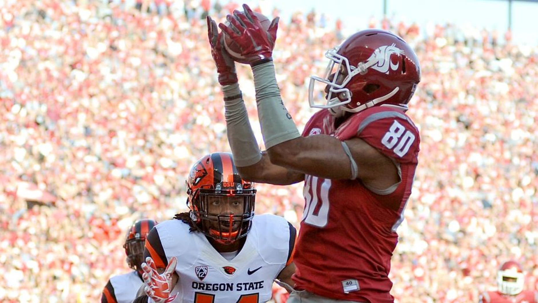 Oct 17, 2015; Pullman, WA, USA; Washington State Cougars wide receiver Dom Williams (80) makes a touchdown catch against Oregon State Beavers cornerback Treston Decoud (14) during the first half at Martin Stadium. Mandatory Credit: James Snook-USA TODAY Sports