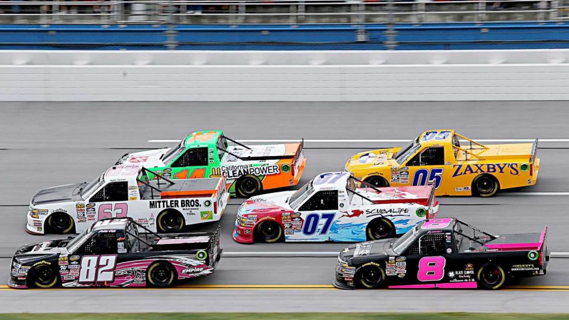 TALLADEGA, AL - OCTOBER 24: Austin Hill, driver of the #82 EmpireRacingDriverDevelopment/B.R.A.K.E.S Ford, and Tyler Tanner, driver of the #63 Mittler Bros./Ski Soda Chevrolet, lead a pack of trucks during the NASCAR Camping World Truck Series fred's 250 at Talladega Superspeedway on October 24, 2015 in Talladega, Alabama. (Photo by Jerry Markland/Getty Images)