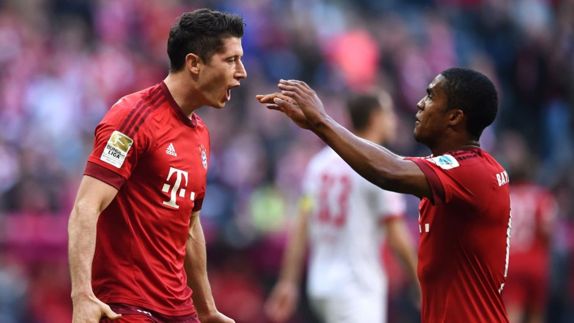 MUNICH, GERMANY - OCTOBER 24: Robert Lewandowski of Muenchen celebrates with his team-mates after scoring his team's third goal during the Bundesliga match between FC Bayern Muenchen and 1. FC Koeln at Allianz Arena on October 24, 2015 in Munich, Germany. (Photo by Matthias Hangst/Bongarts/Getty Images)