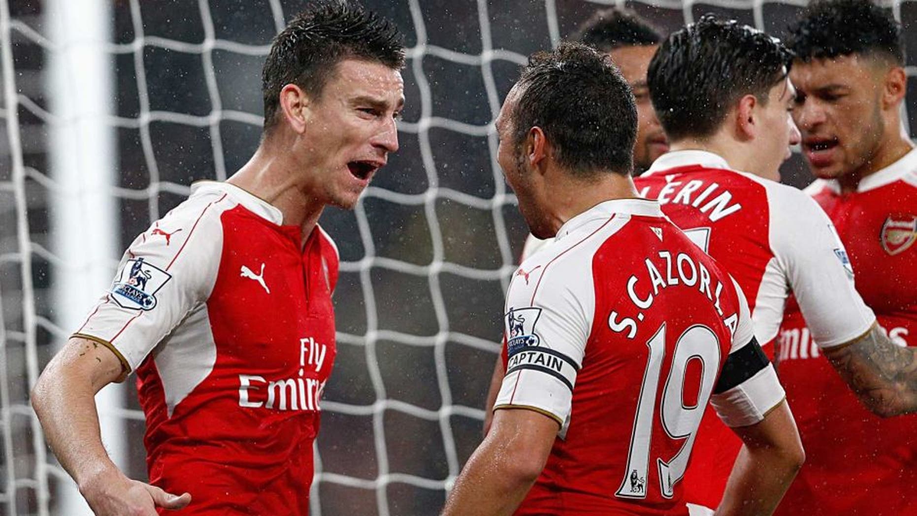 LONDON, ENGLAND - OCTOBER 24: Laurent Koscielny (L) of Arsenal celebrates scoring his team's second goal with his team mates during the Barclays Premier League match between Arsenal and Everton at Emirates Stadium on October 24, 2015 in London, England. (Photo by Dean Mouhtaropoulos/Getty Images)