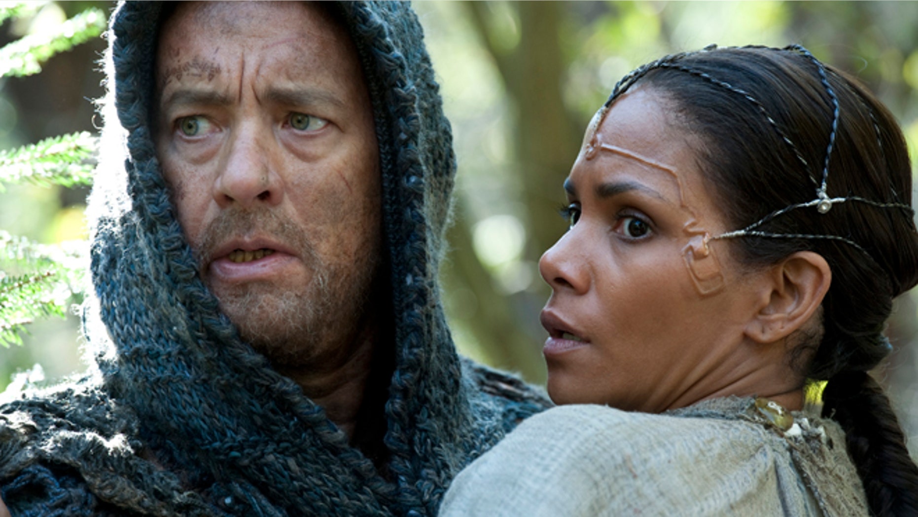 This film image released by Warner Bros. Pictures shows Tom Hanks as Zachry and Halle Berry as Meronym in a scene from "Cloud Atlas."