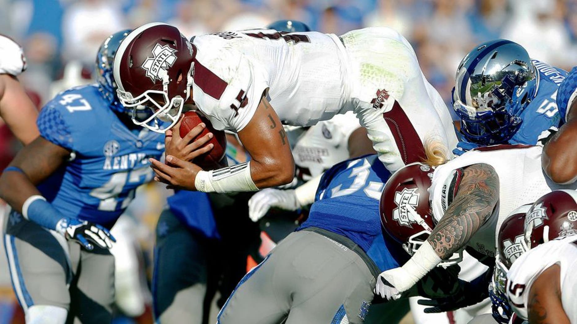 Oct 25, 2014; Lexington, KY, USA; Mississippi State Bulldogs quarterback Dak Prescott (15) dives for a touchdown against the Kentucky Wildcats in the first half at Commonwealth Stadium. Mandatory Credit: Mark Zerof-USA TODAY Sports